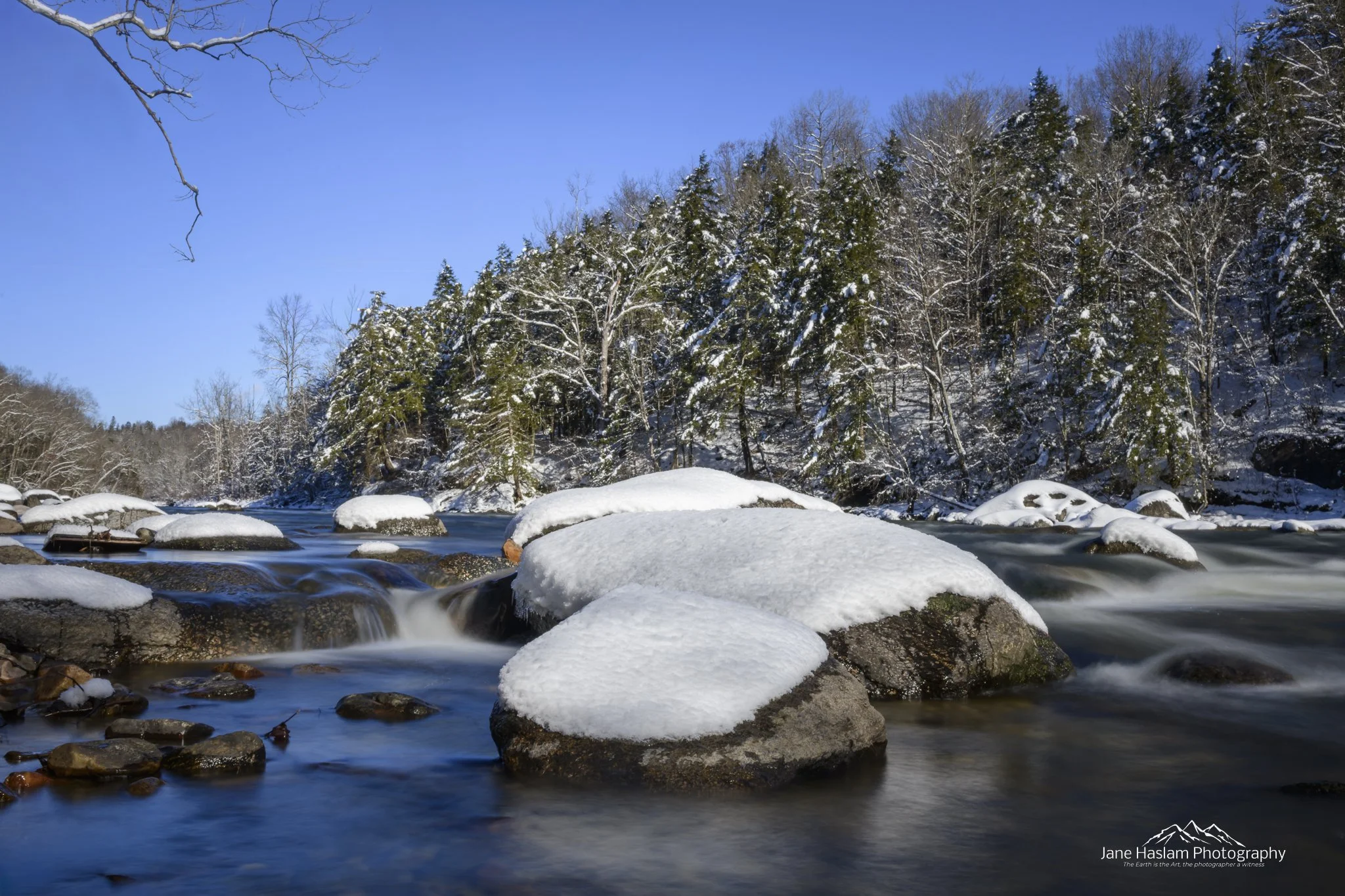 Long exposure winter landscape of the Housatonic River near Bulls Bridge in bright winter sunshine, Kent, Connecticut