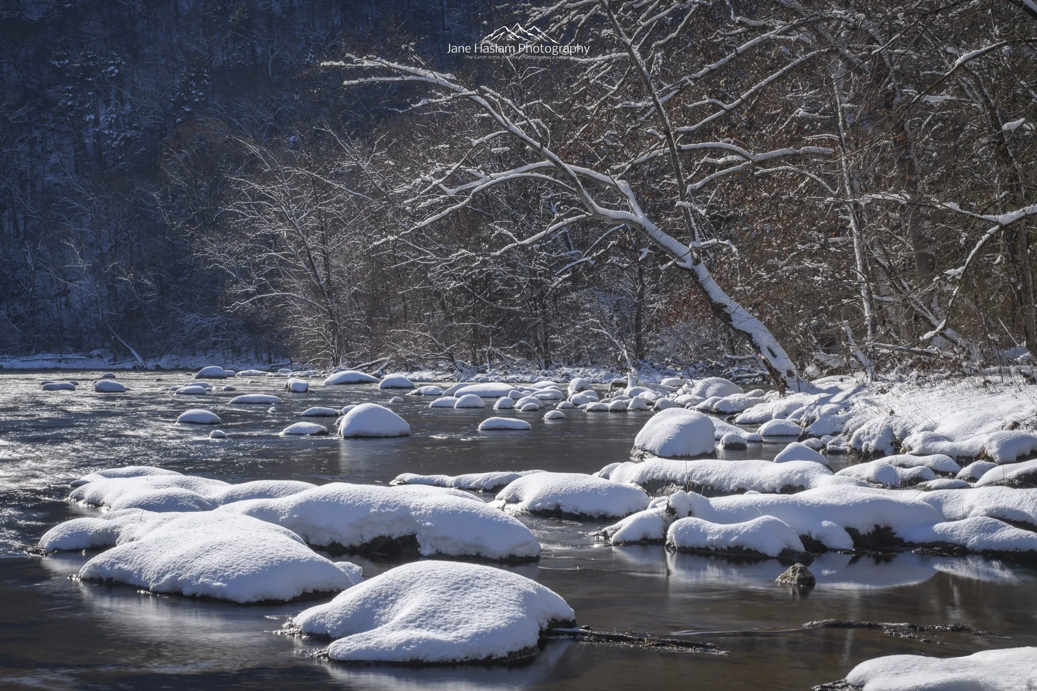 Becalmed: Fresh snow and winter sunshine on the calm Housatonic River, western Connecticut, long exposure nature photography