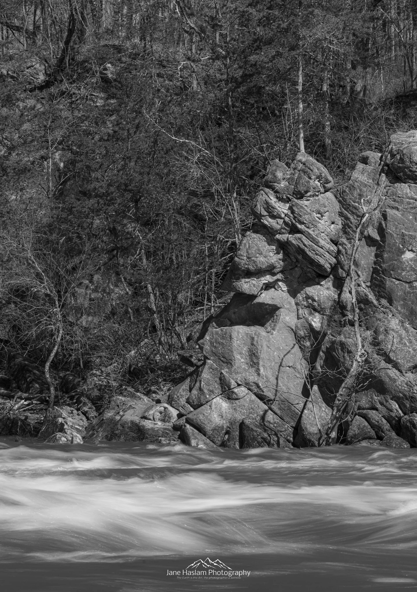 Black and white photograph of ancient river rocks and spring meltwater on the Housatonic River at Bulls Bridge, Kent, Connecticut