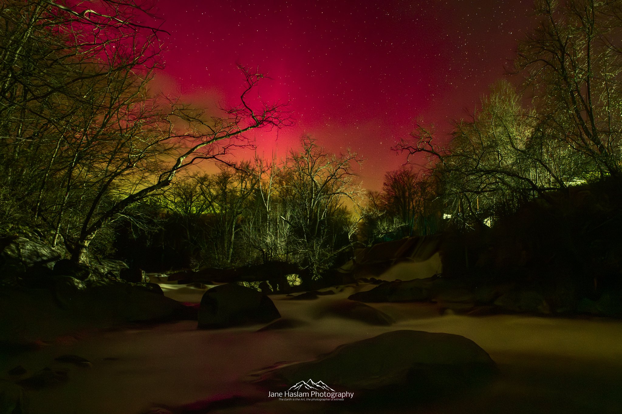 When the sky Ignites: A strong Aurora with a deep crimson sky over the snow-covered rapids at Bulls Bridge on the Housatonic River  Western Connecticut
