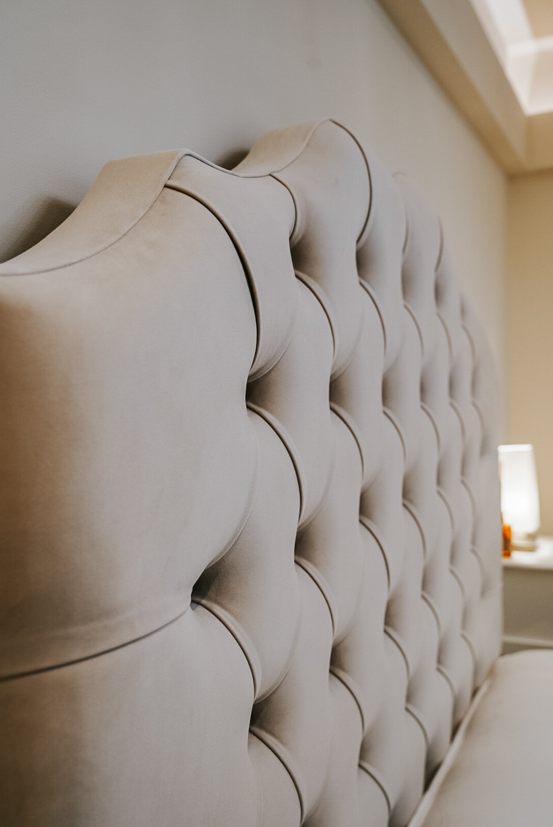 Tufted upholstered bed headboard in neutral color