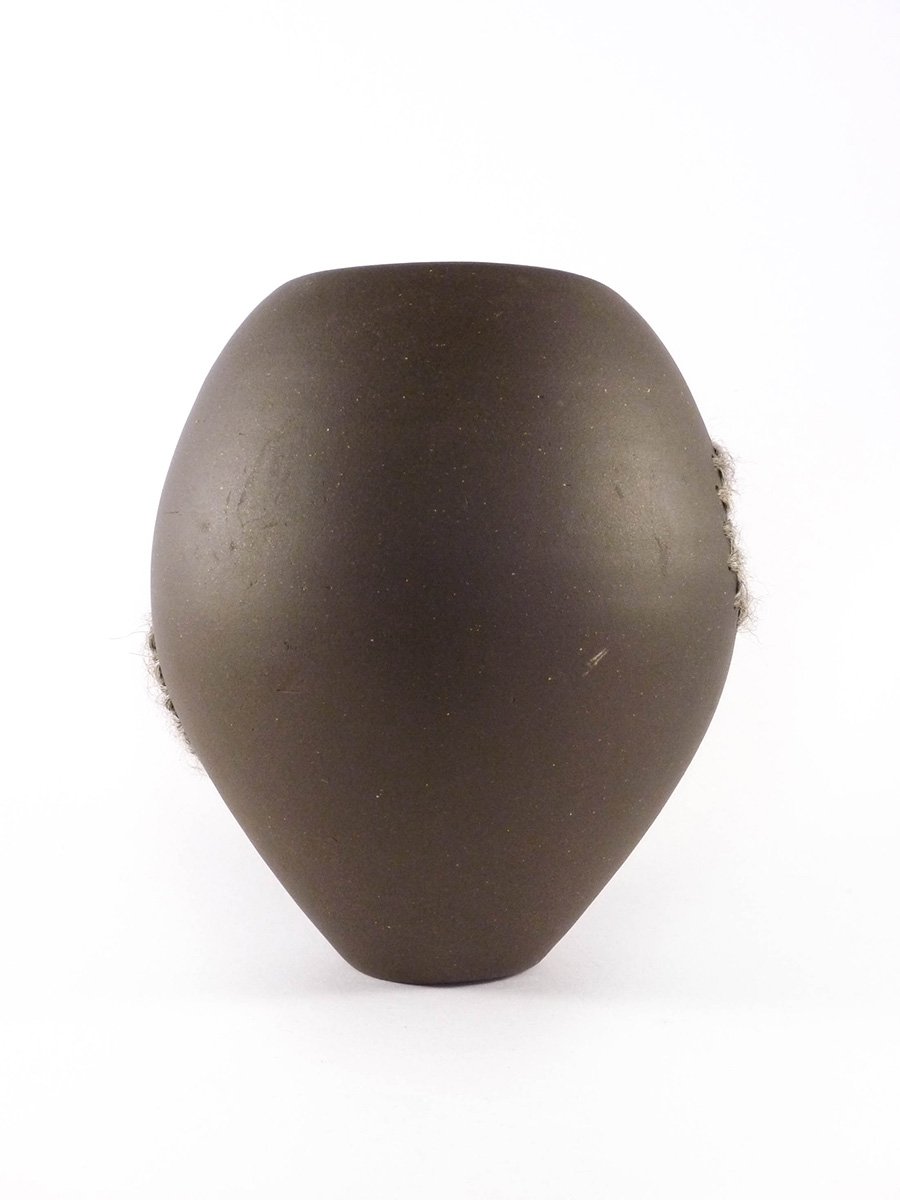 Black pottery sculpture on white background