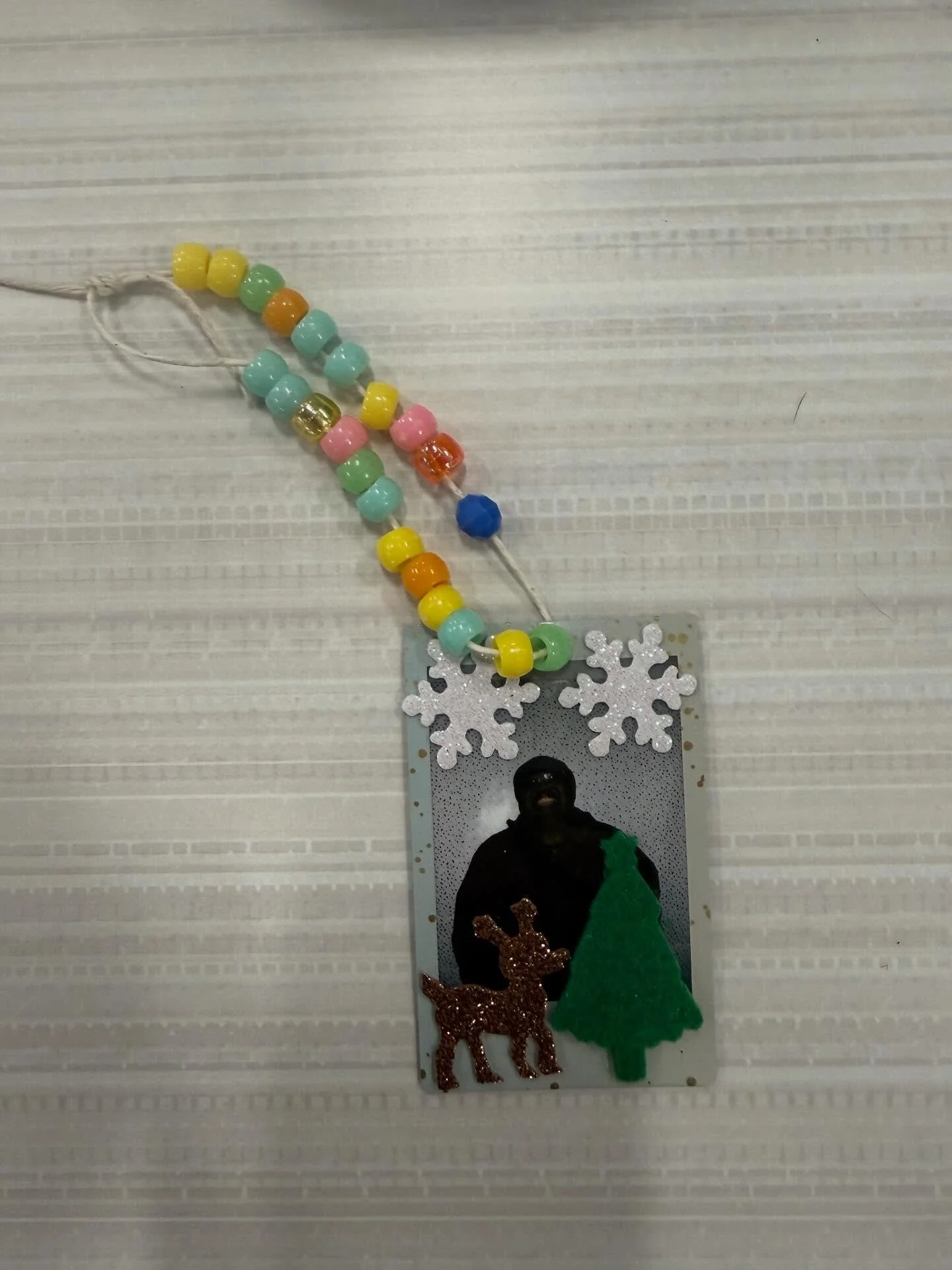 We went to the bay village library, made a Xmas snack with popcorn, pretzels, m&amp;ms and marshmallows.
They used a Polaroid to take his picture, then we punched a hole at the top, added ribbons, beads and sticks to turn it into an ornament.
We also