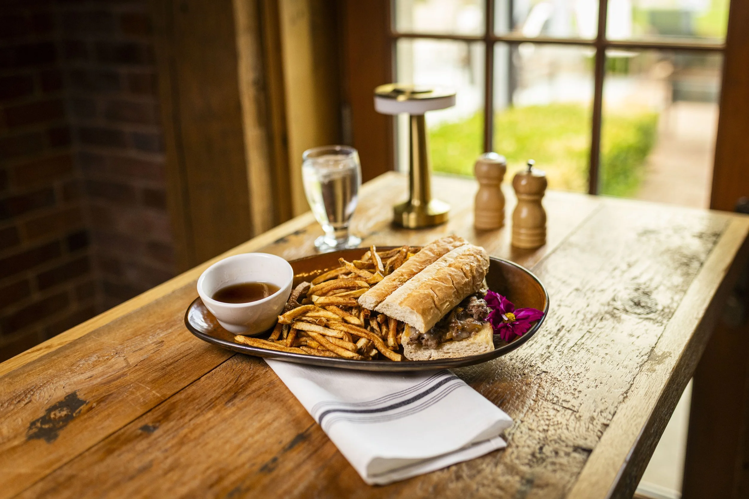 Double roasted prime rib sandwich with gruyère, caramelized onions, and thyme au jus at Peter Allen Inn