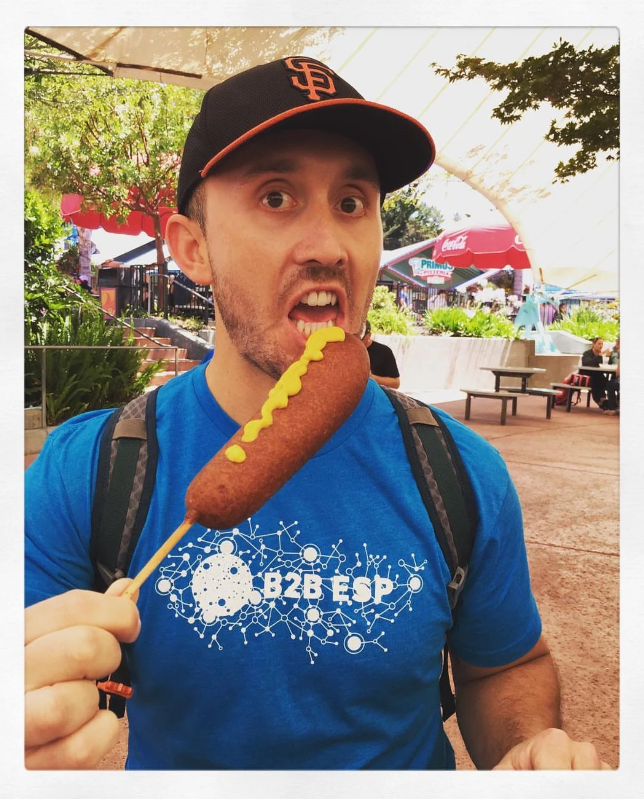 Ben Coffee holding a comically large corndog