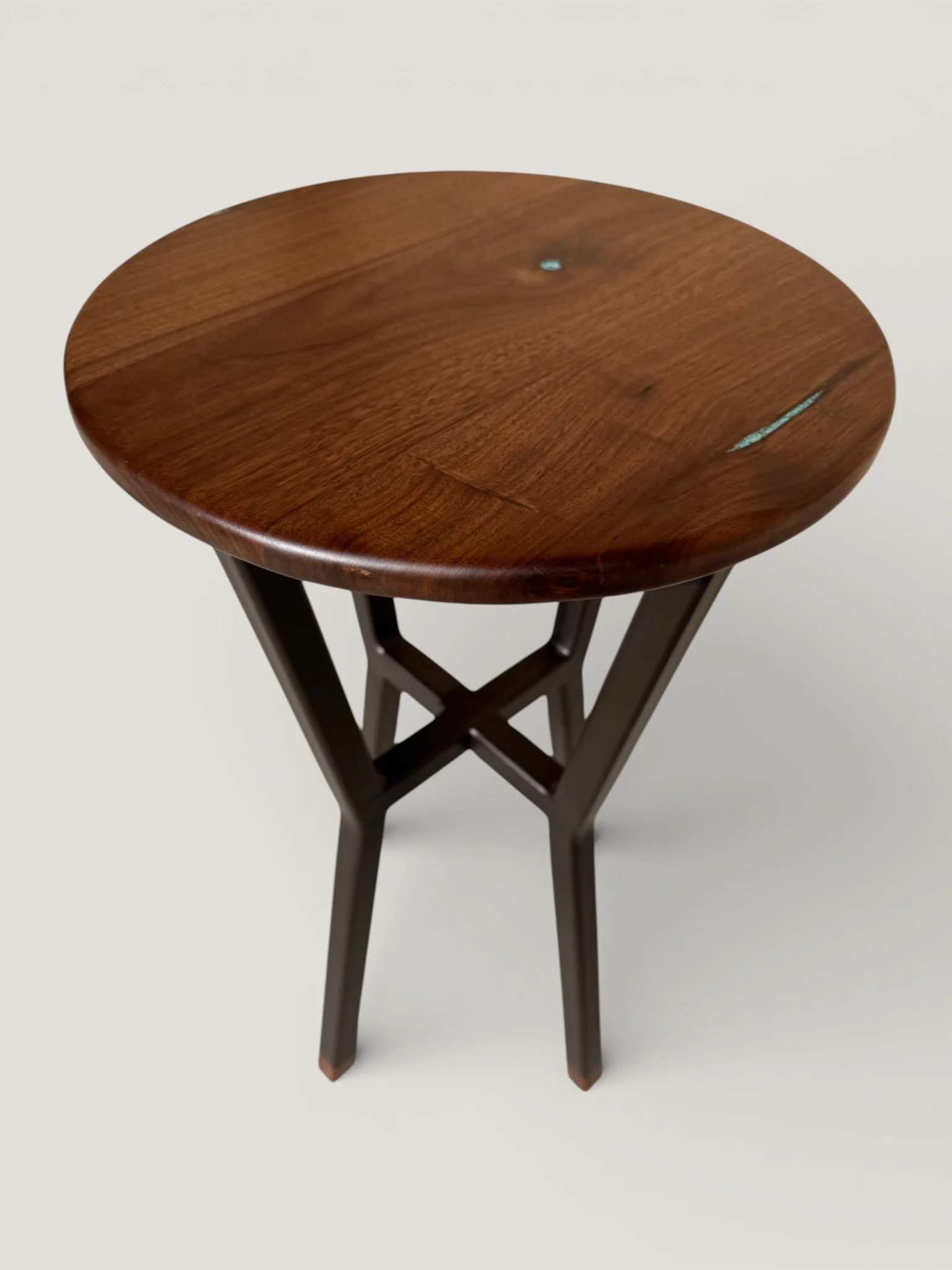 WALNUT ON A BLACK POWDER COATED METAL BASE WITH WALNUT FEET AND TURQUOISE INLAY. 12" D X 18" 