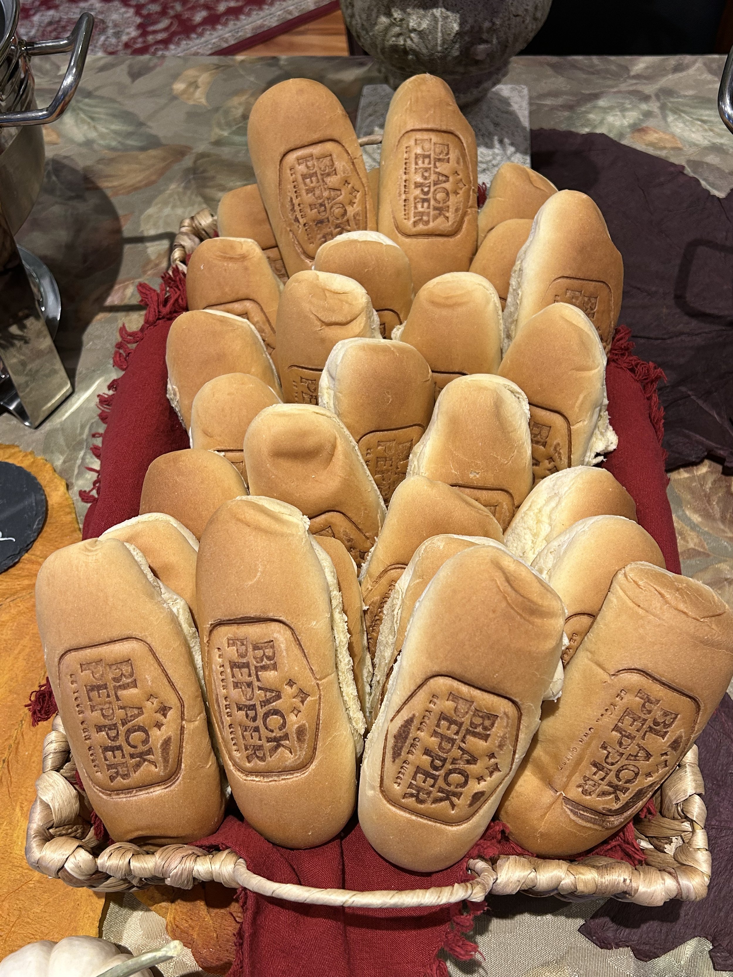 Basket of bread rolls with the Black Pepper logo.