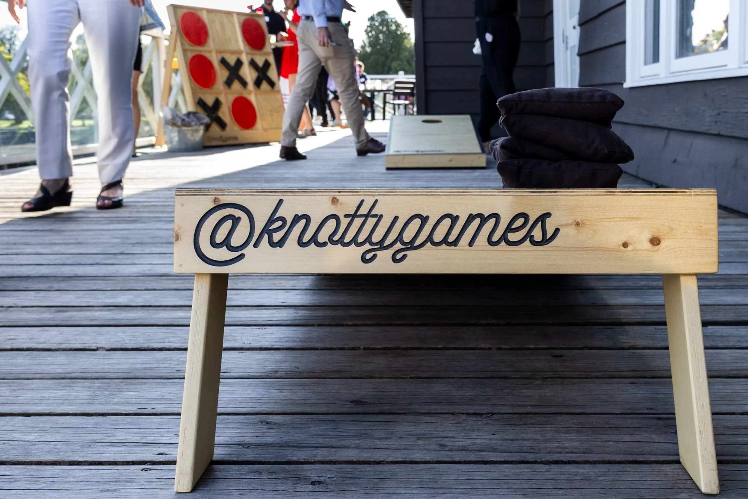 The back of a branded Knotty Games cornhole board