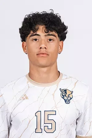 Young man with curly black hair wearing a white sports jersey with a panther logo and the number 15, standing against a plain background.