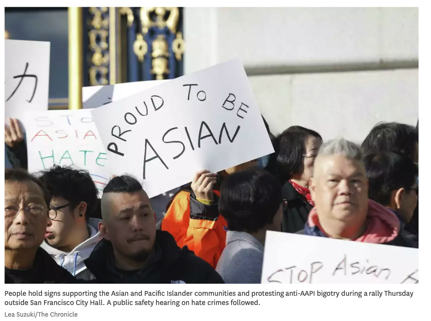 People hold signs supporting the Asian and Pacific Islander communities and protesting anti-AAPI bigotry during a rally Thursday outside San Francisco City Hall. A public safety hearing on hate crimes followed.