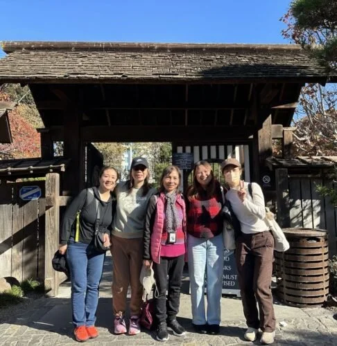 Yumei Lu poses with 4 other CPA members outside.