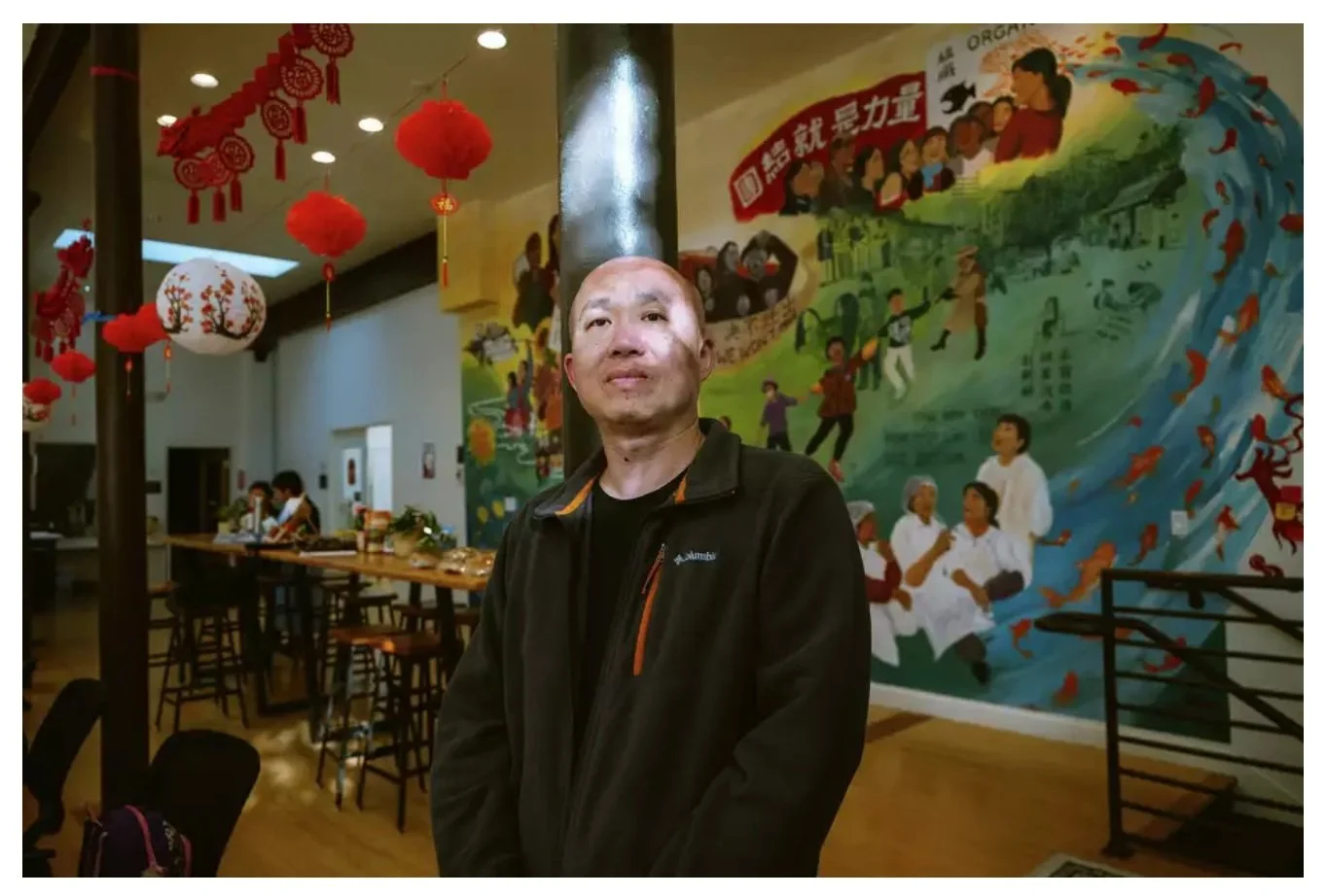 A man standing in front of a mural.