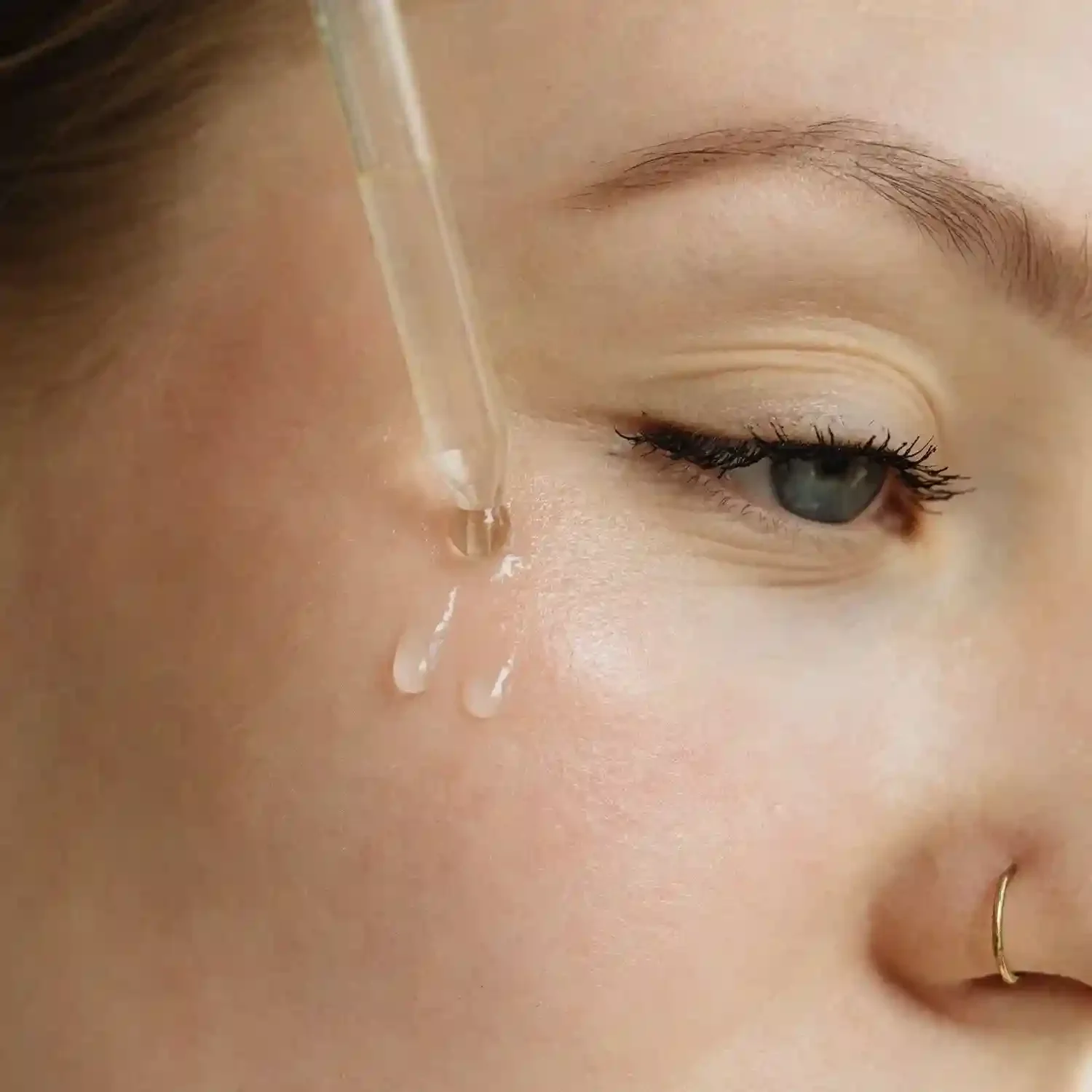 Close up of woman applying skincare treatment
