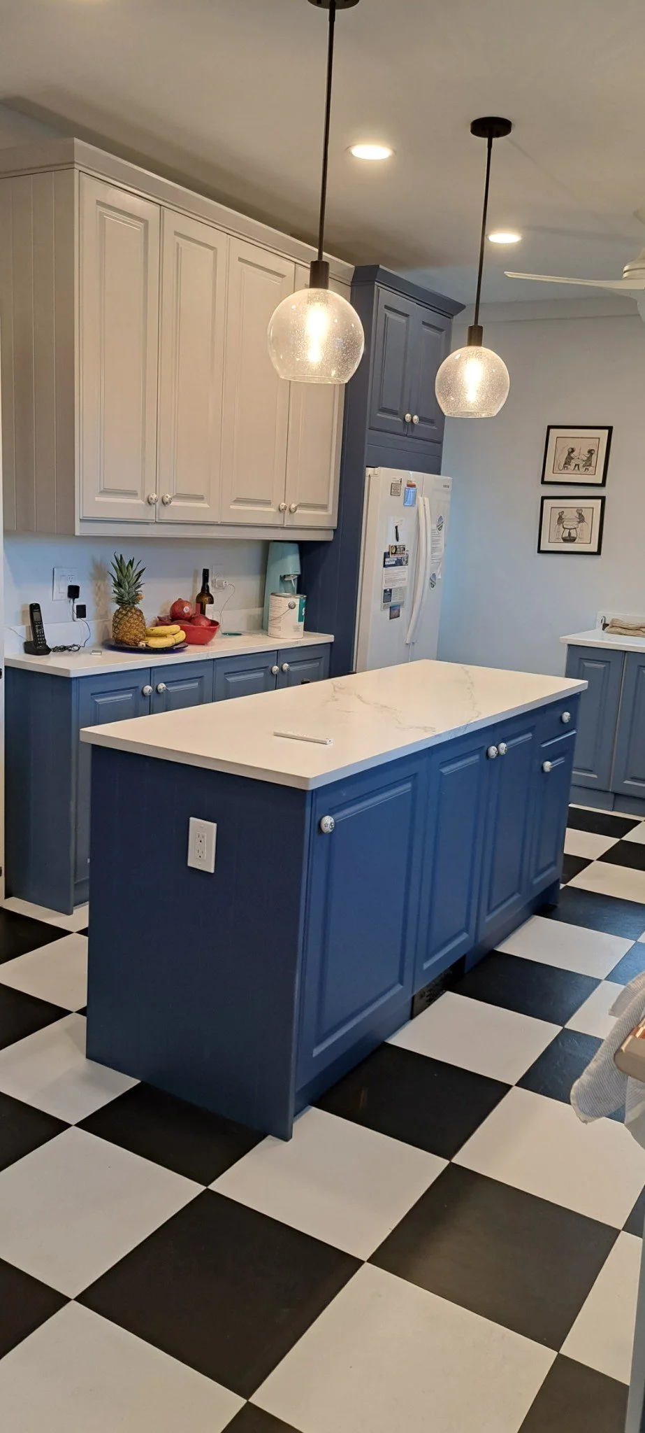 Checkerboard floor, navy island, smoke blue base, pebble gray wall cabinets