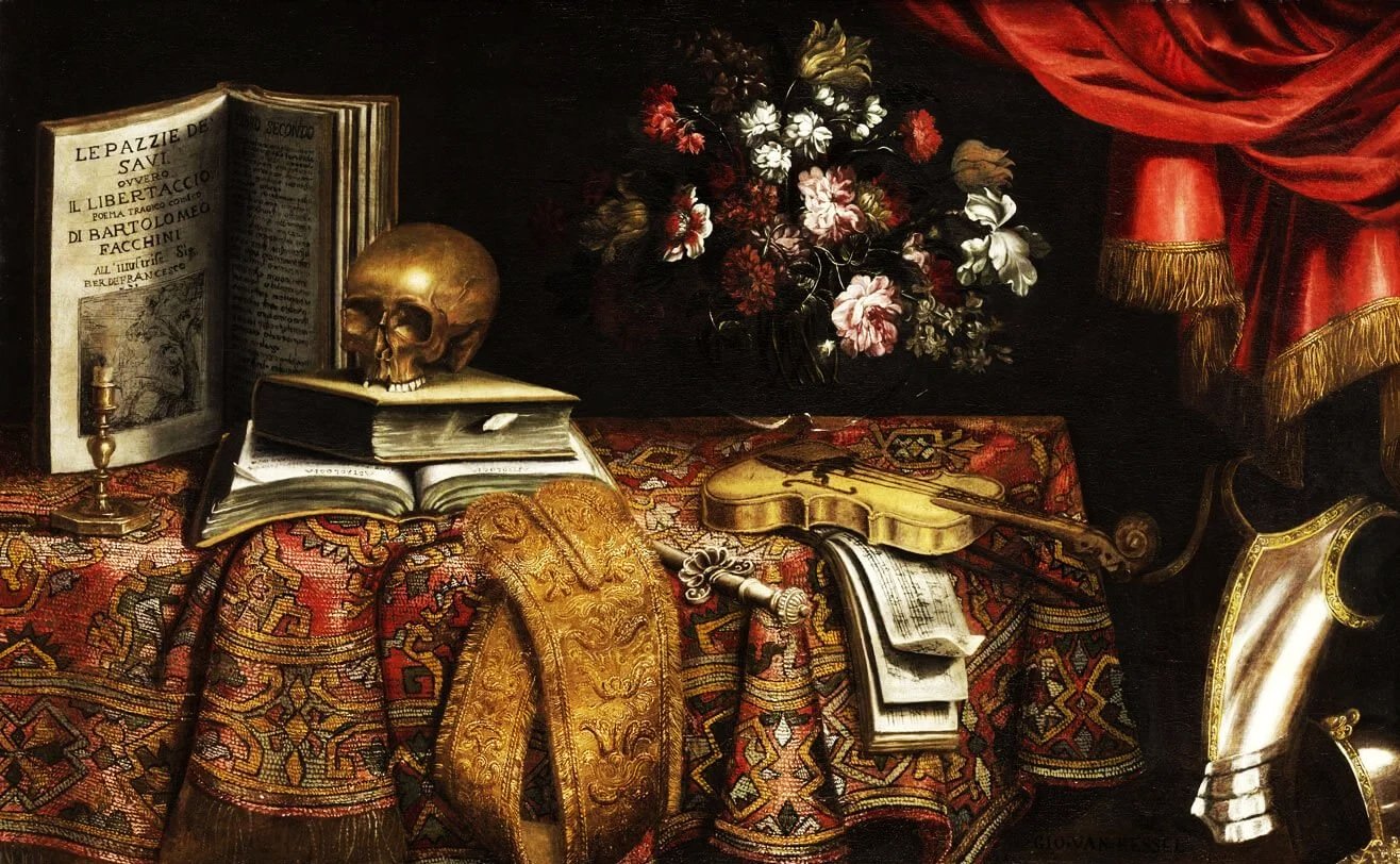 Vanitas Still Life with a violin, open books, a human skull, sheet music, embroidered fabric, fresh flowers, and pieces of armor arranged on a table in a richly detailed 17th-century still life.