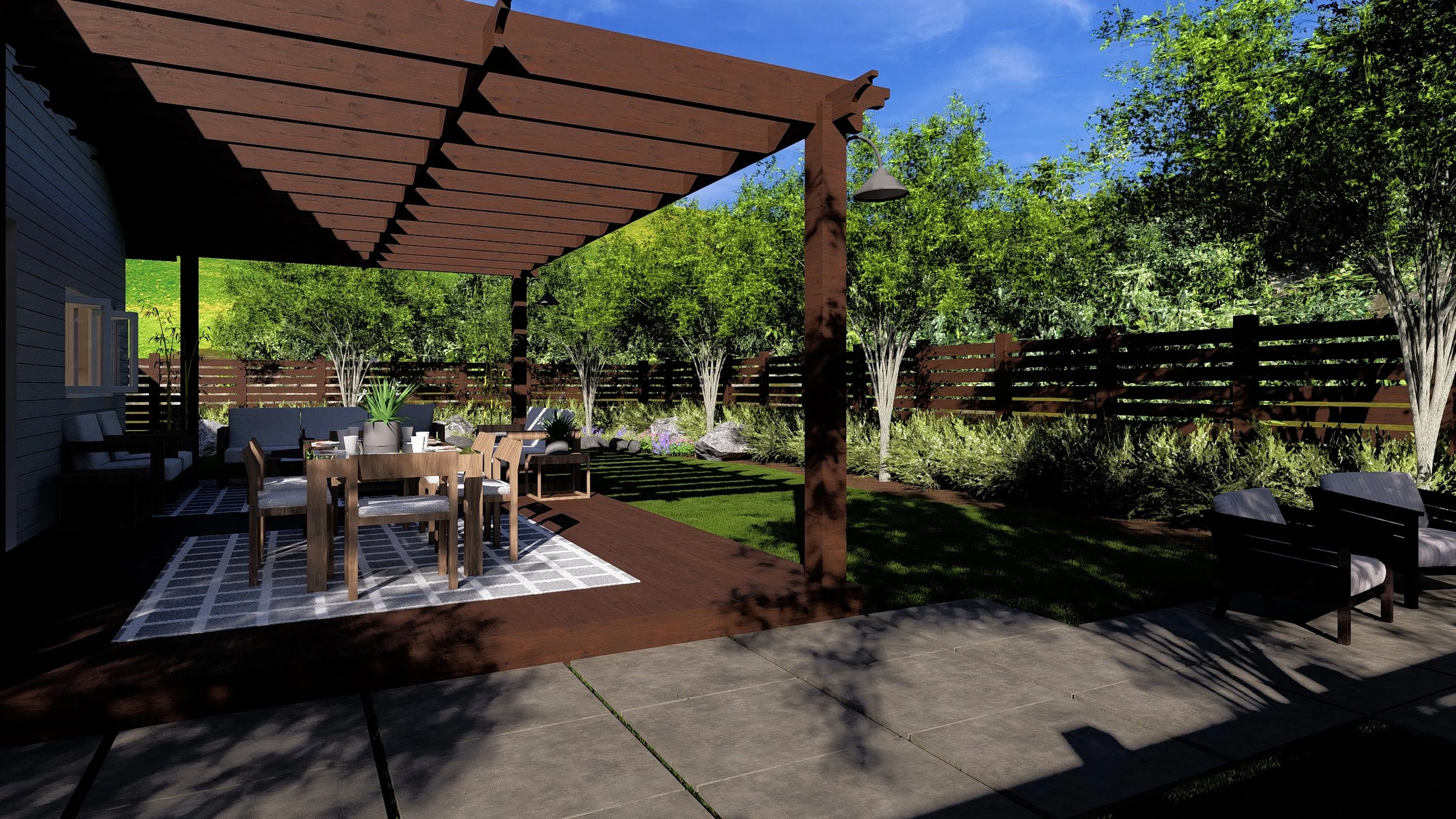 A backyard patio with a wooden pergola, outdoor dining table, chairs, and seating area surrounded by green trees and a wooden fence.