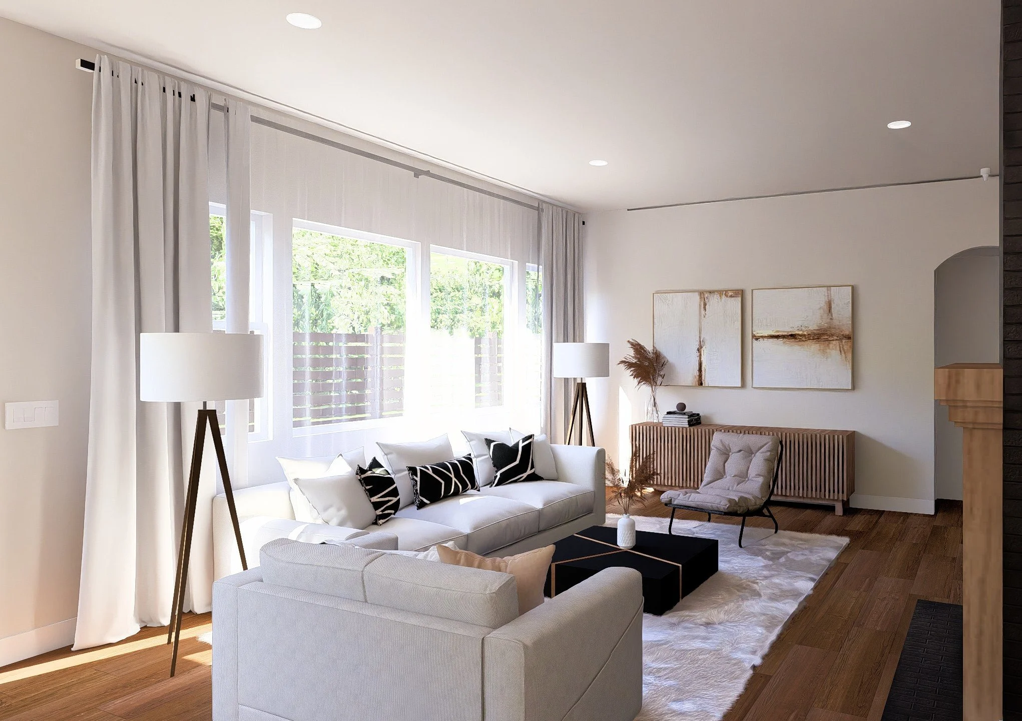 Modern living room with white sofa, area rug, side chair, large windows with curtains, and wall art.