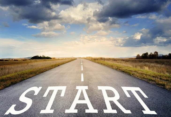 Open road in rural landscape with cloudy sky, marked with the word 'START' at the beginning.