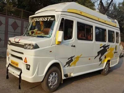 White tourist minibus with black horse and yellow lightning bolt decals parked outdoors.