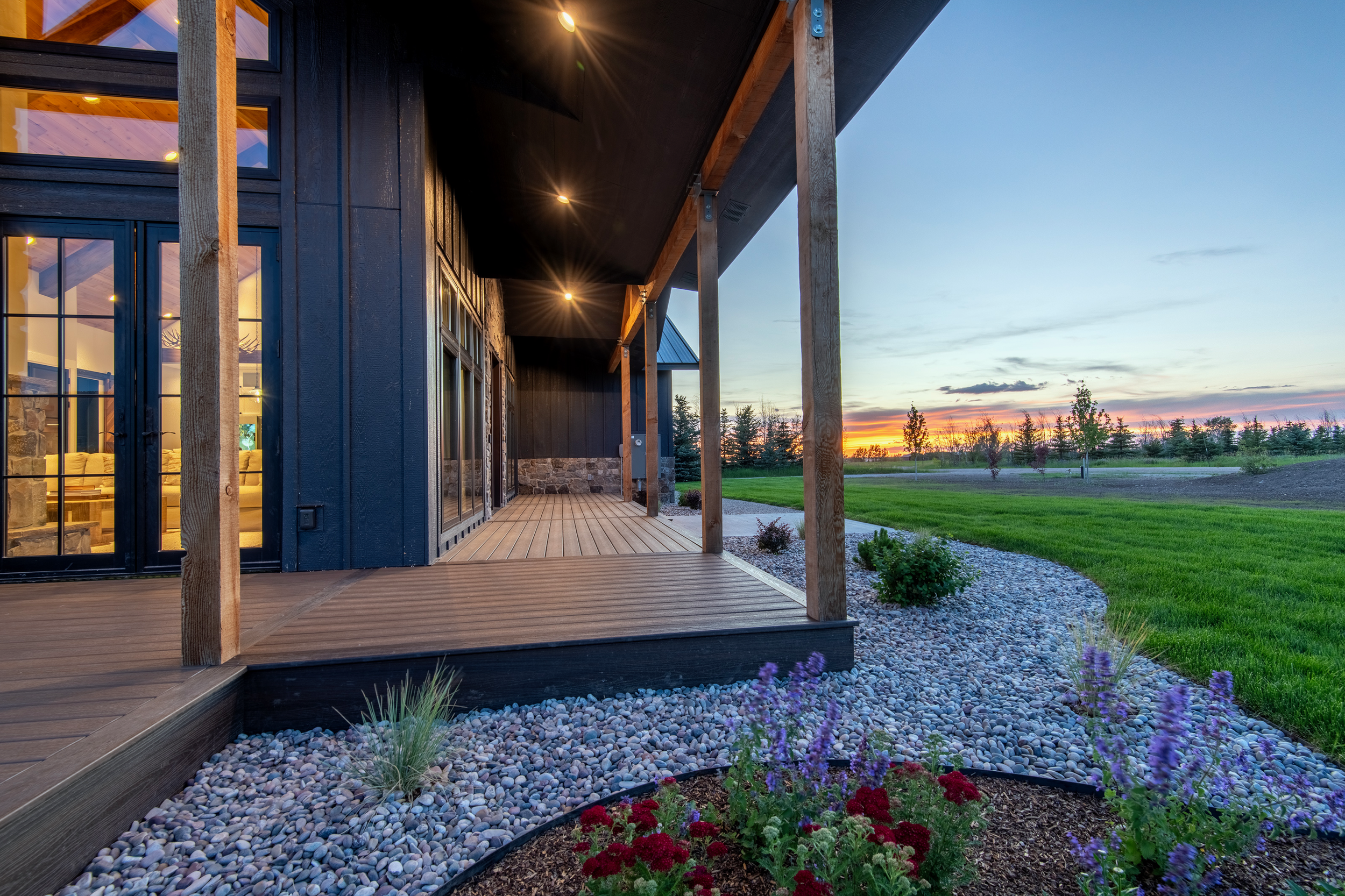 Spacious outdoor deck with multiple seating areas and hot tub, surrounded by stunning Teton Valley scenery at vacation home near Jackson Hole