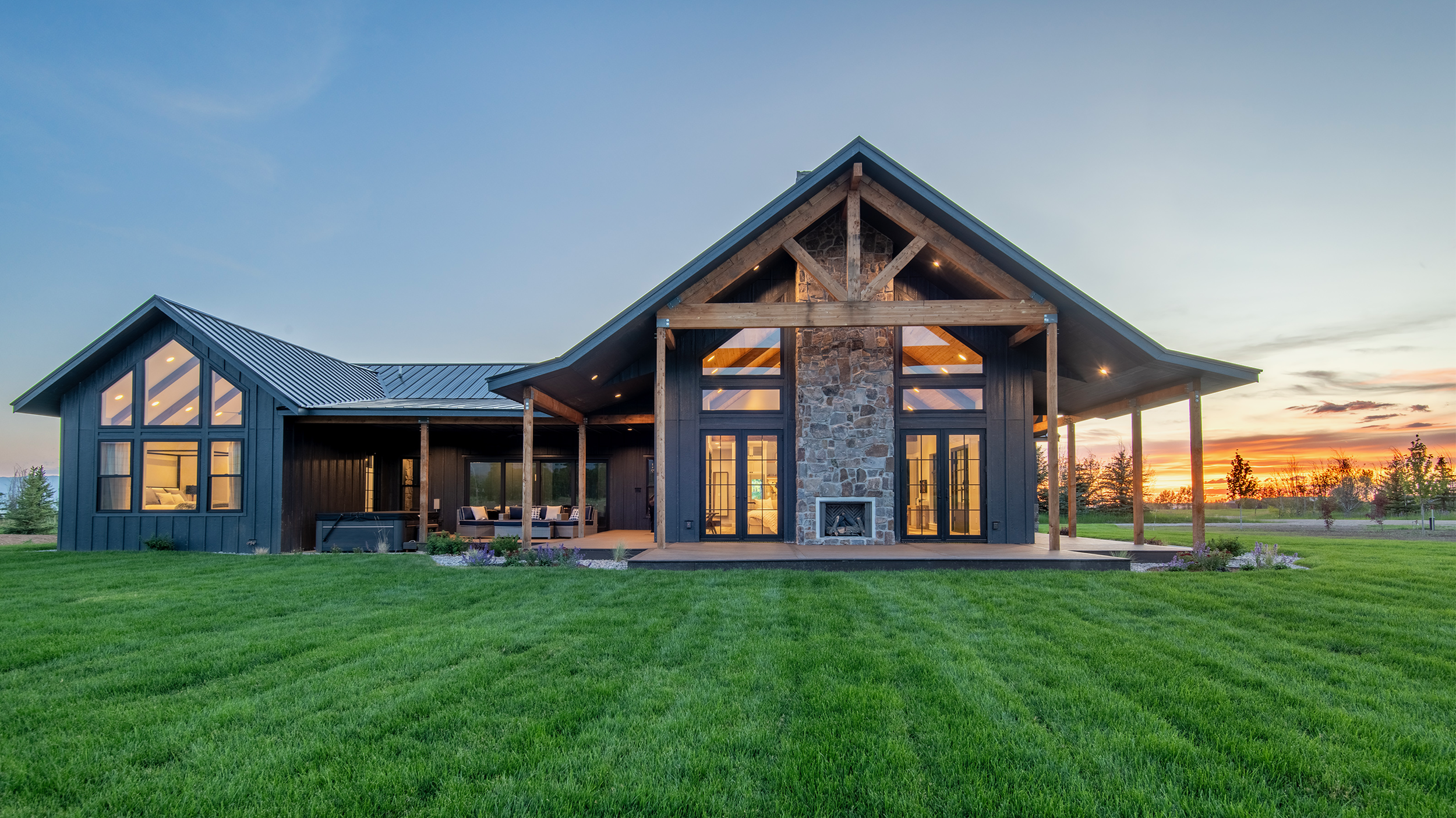 Wraparound deck designed for entertaining, with dining space, grill, and panoramic mountain views at Driggs luxury vacation rental near Grand Targhee Ski Resort