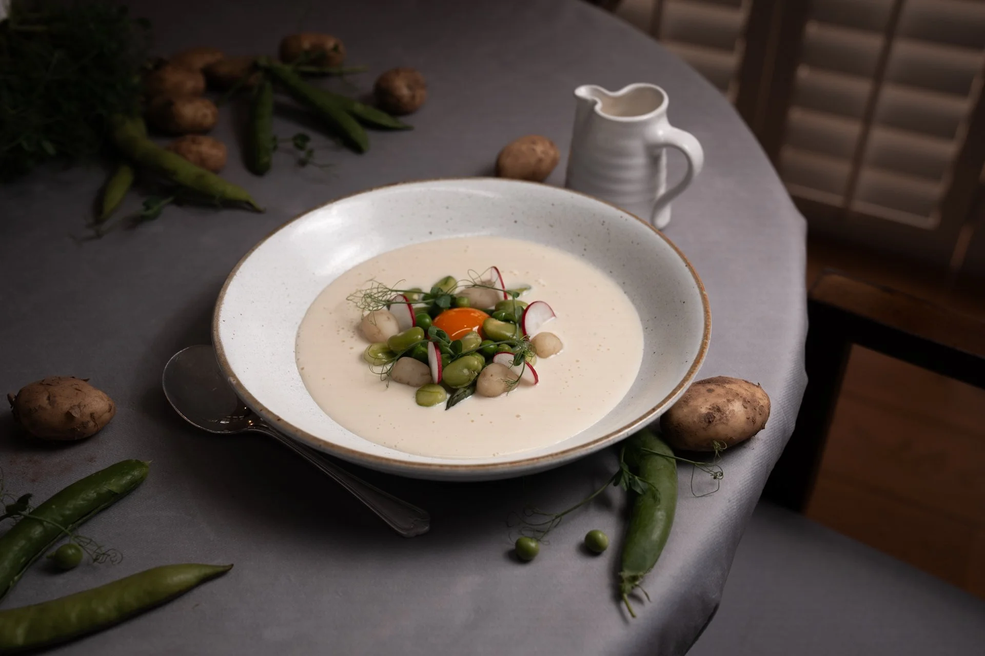 Jersey Royal Velouté with Smoked Egg Yolk, Summer Vegetables, and Pea Shoots by Will Holland