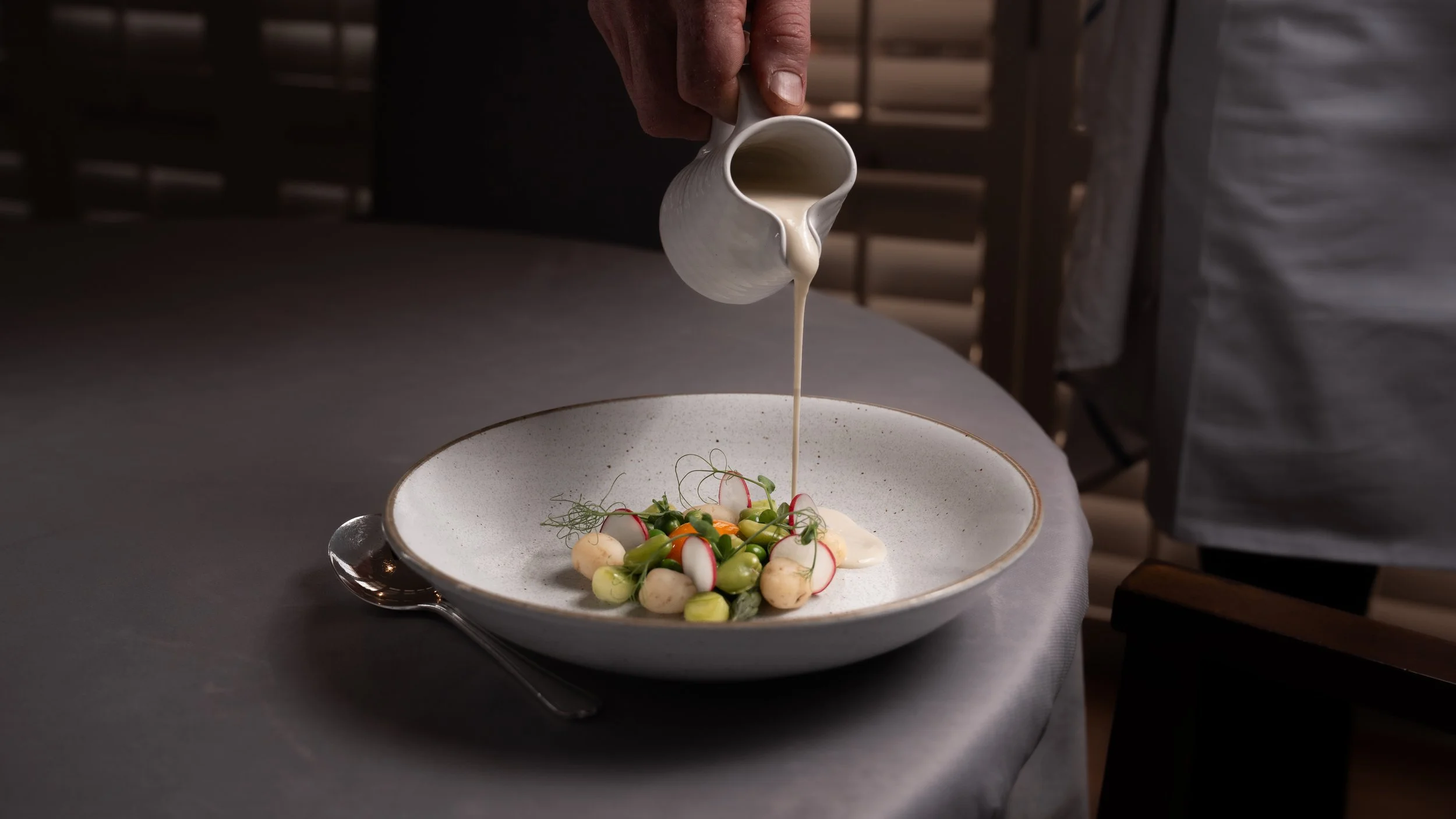 Jersey Royal Velouté with Smoked Egg Yolk, Summer Vegetables, and Pea Shoots