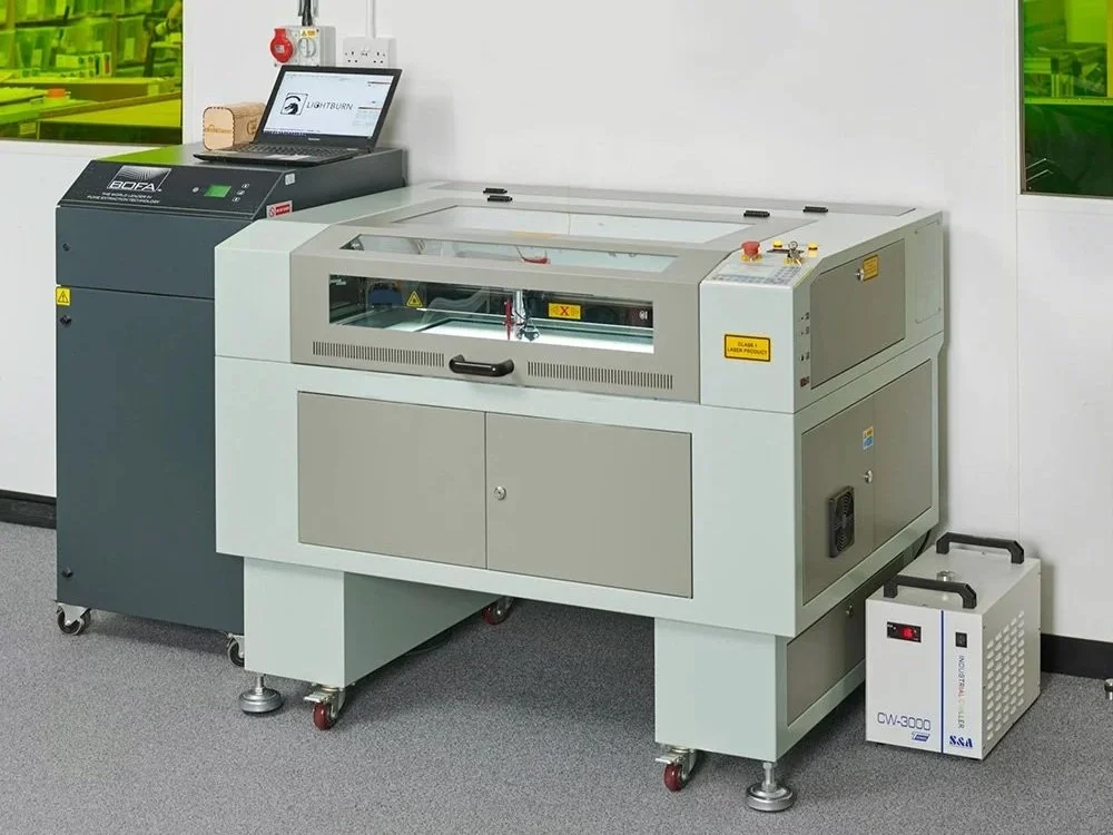 Example of our Vision 4060 Laser System, paired with a BOFA filtration unit positioned to the left of the machine.