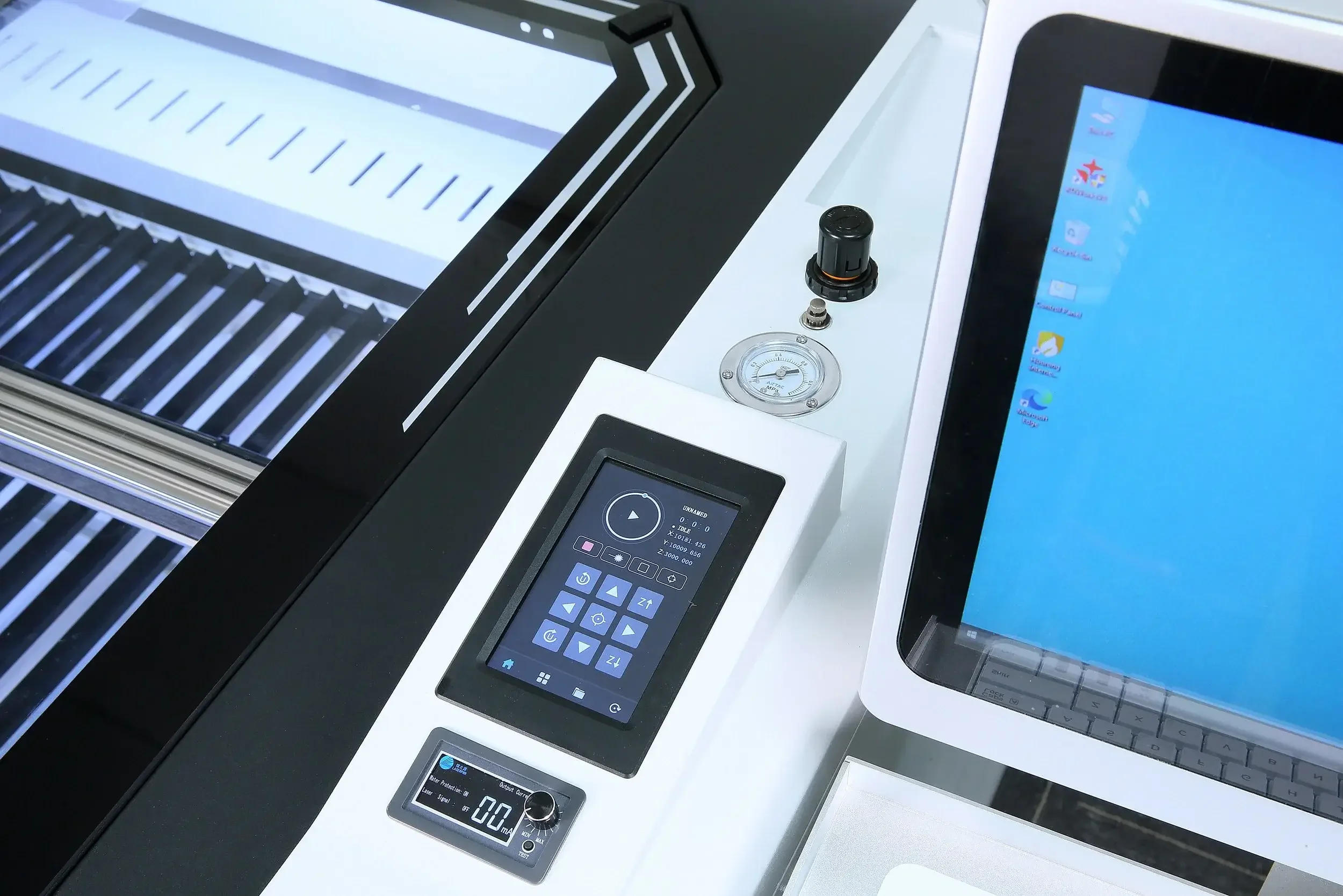 Industrial control panel with emergency stop button, a key switch, and a touchscreen display showing a handprint scan, with machinery in the background.