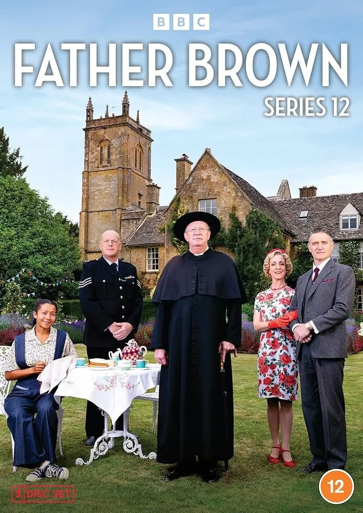 Cover of the BBC Father Brown Series 12 DVD featuring five characters standing outdoors in front of a large house, with a table set for tea, lush greenery, and a church tower in the background.