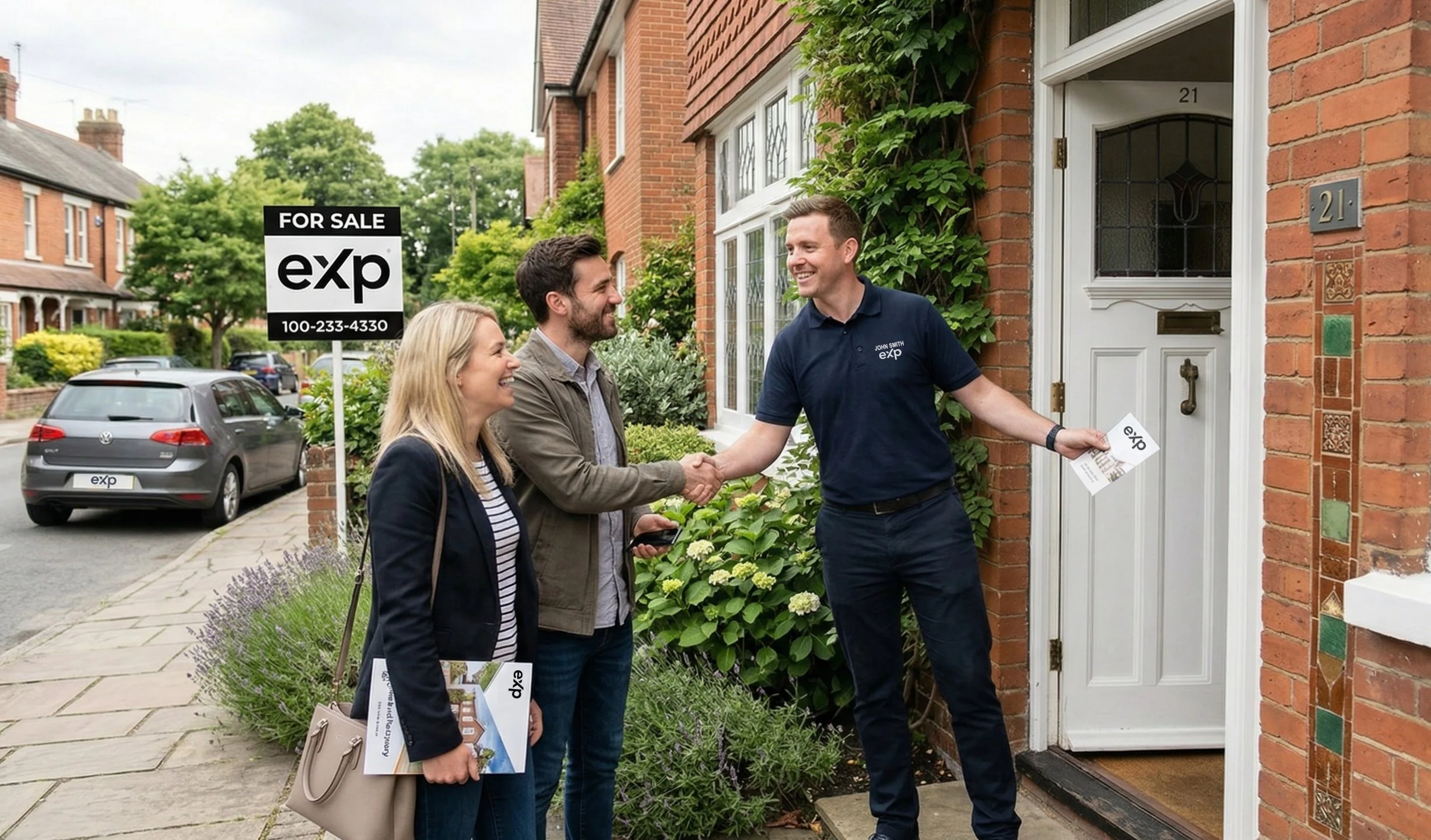 A real estate agent shaking hands with a couple outside a brick house for sale. The agent is holding a brochure and wearing a navy shirt with the logo ‘eXp’ and the name ‘John Smith’. The couple is smiling and holding marketing materials. The house has a white door with the number 21 and looks inviting. There is a ‘For Sale’ sign from ‘eXp’ real estate company on the lawn.