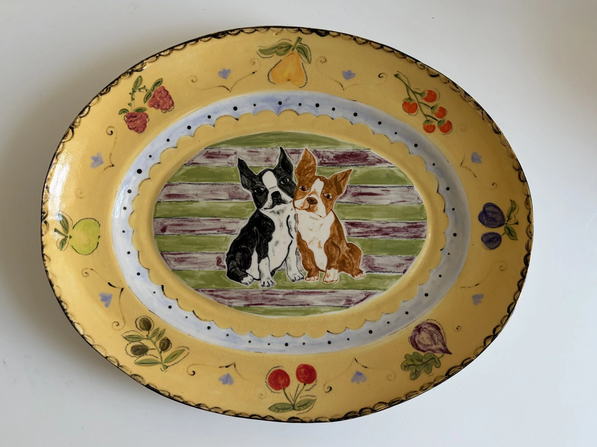 (Custom 9-inch white stoneware platter with botanical detail and two dog portraits. Fully glazed; food & dishwasher safe)