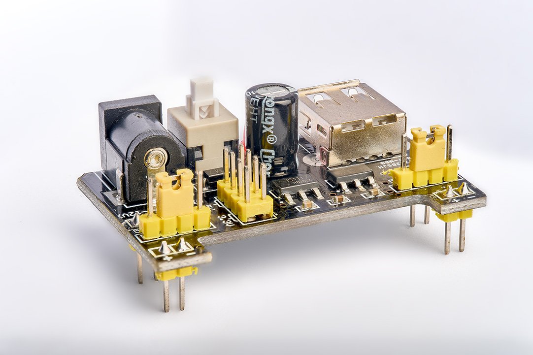 Close up product shot of a miniature power supply unit (PSU) on a white background.