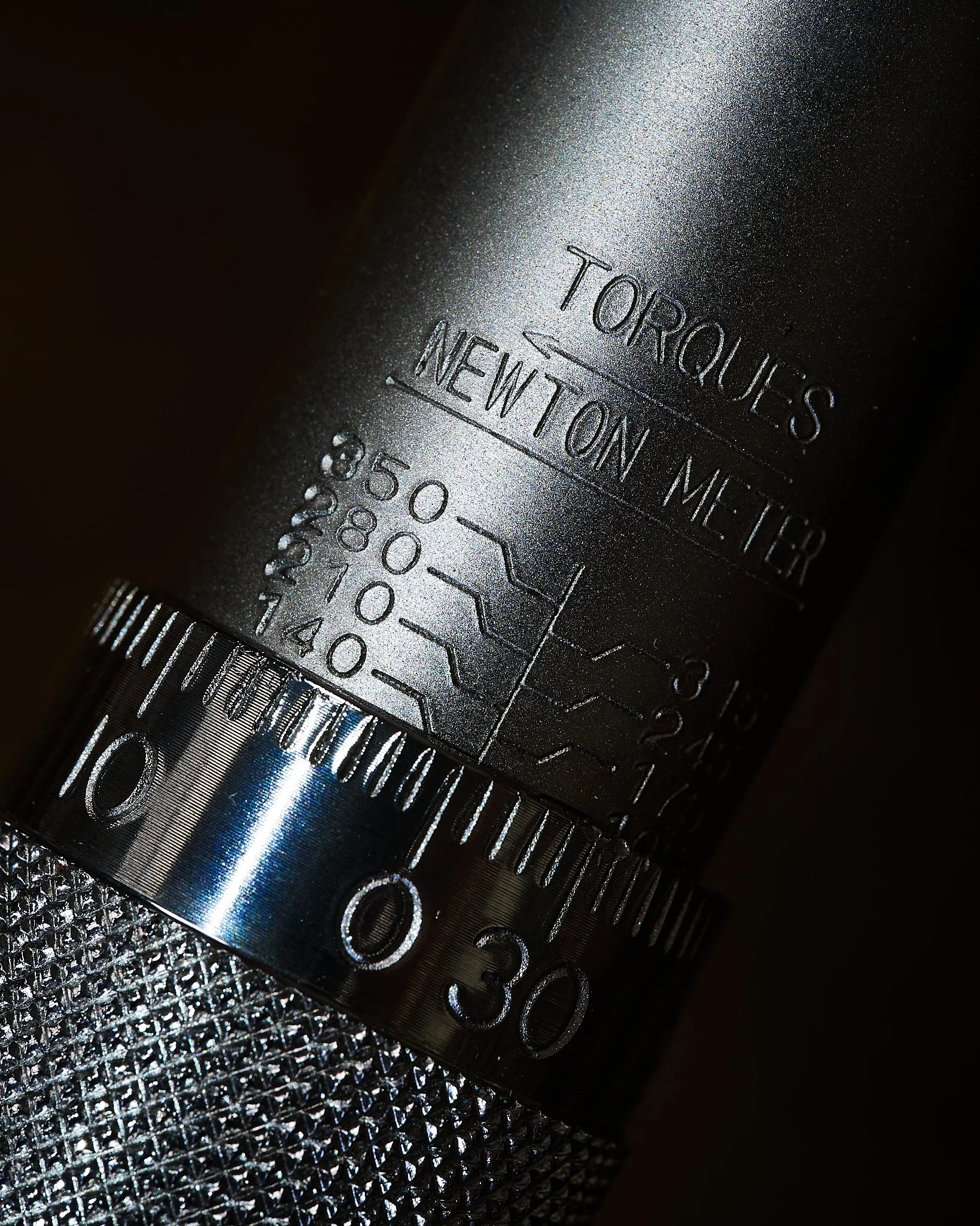 Close up detail photograph of the micrometrical scale on a torque wrench.
