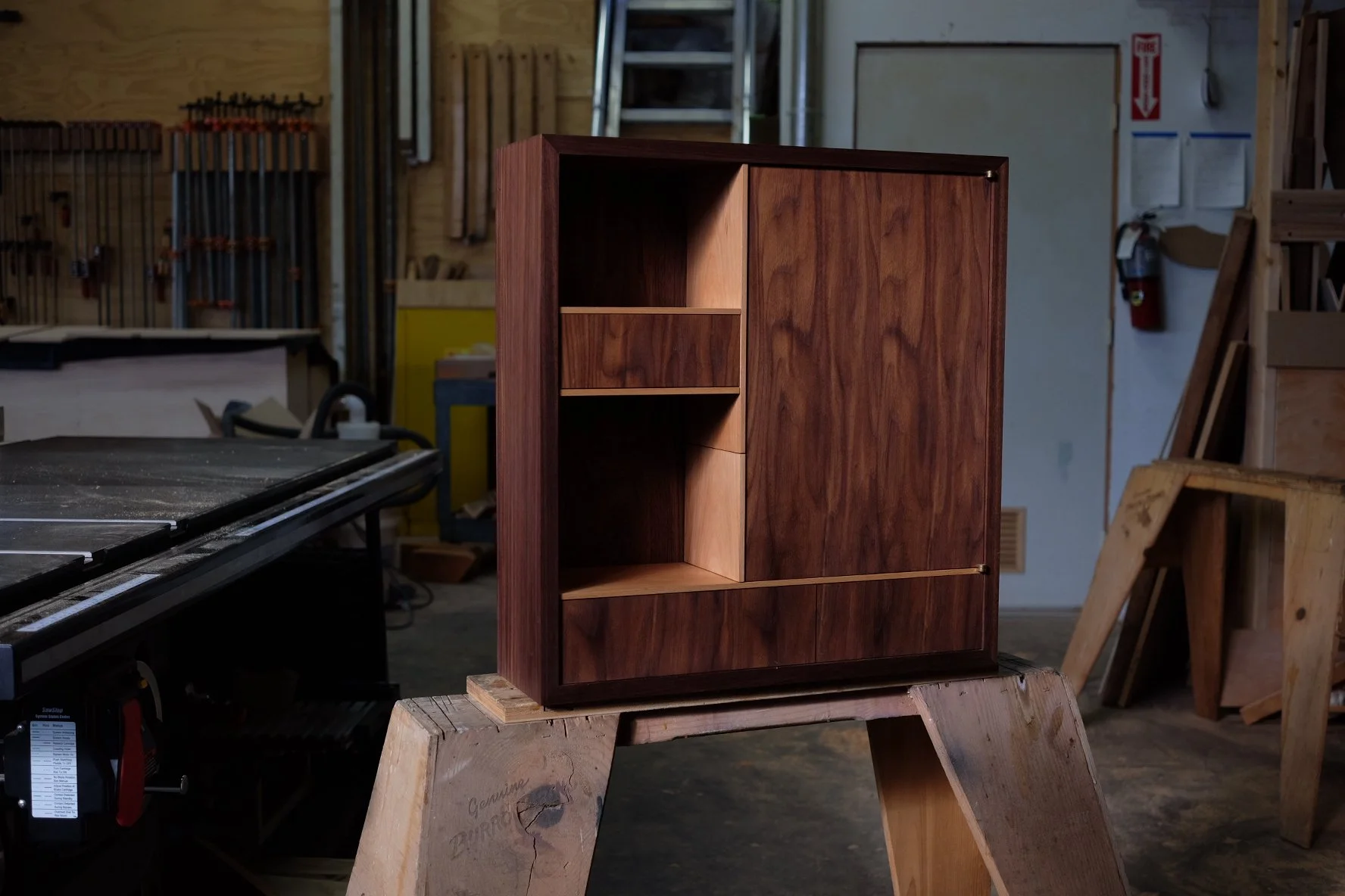 A handmade wall-hung walnut and beech cabinet.