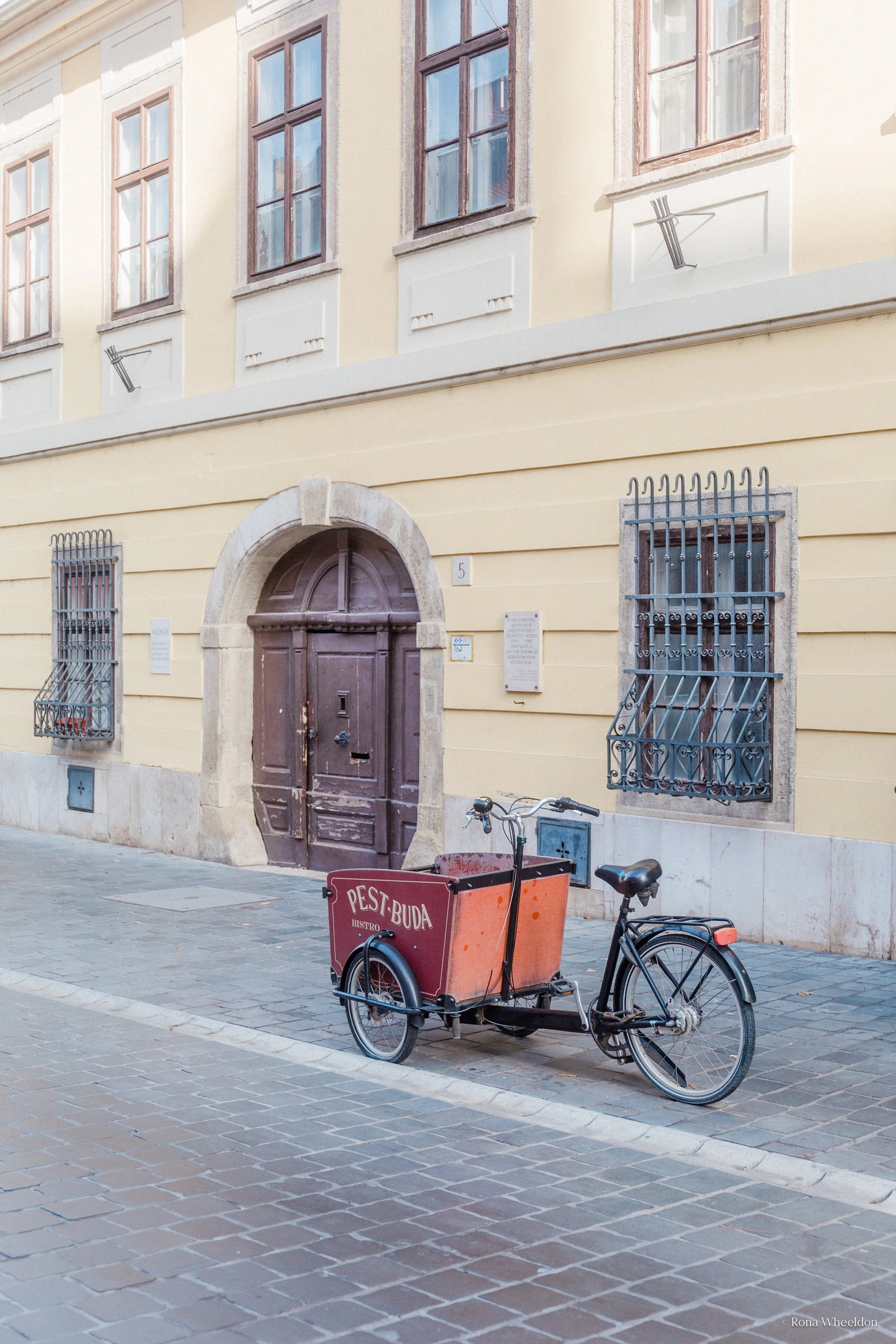 Local restaurant delivery tricycle on the cobbled streets