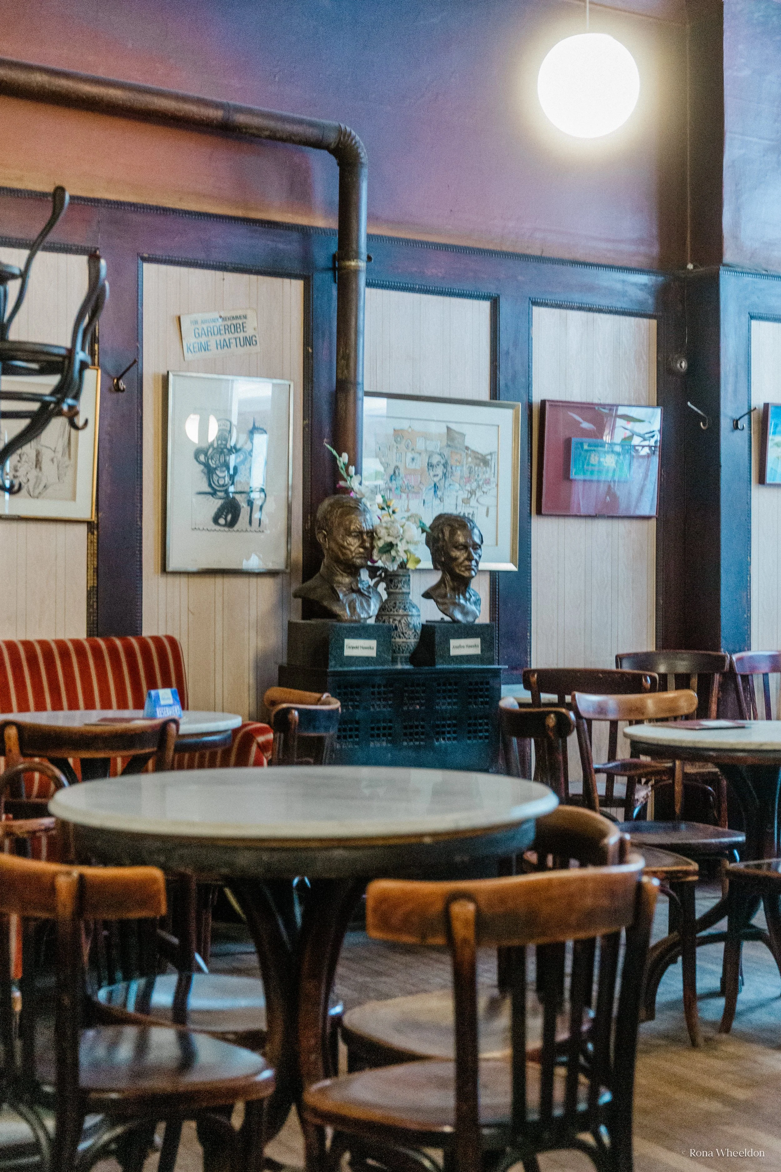 Rustic, dark furniture &amp; panelling inside Cafe Hawelka