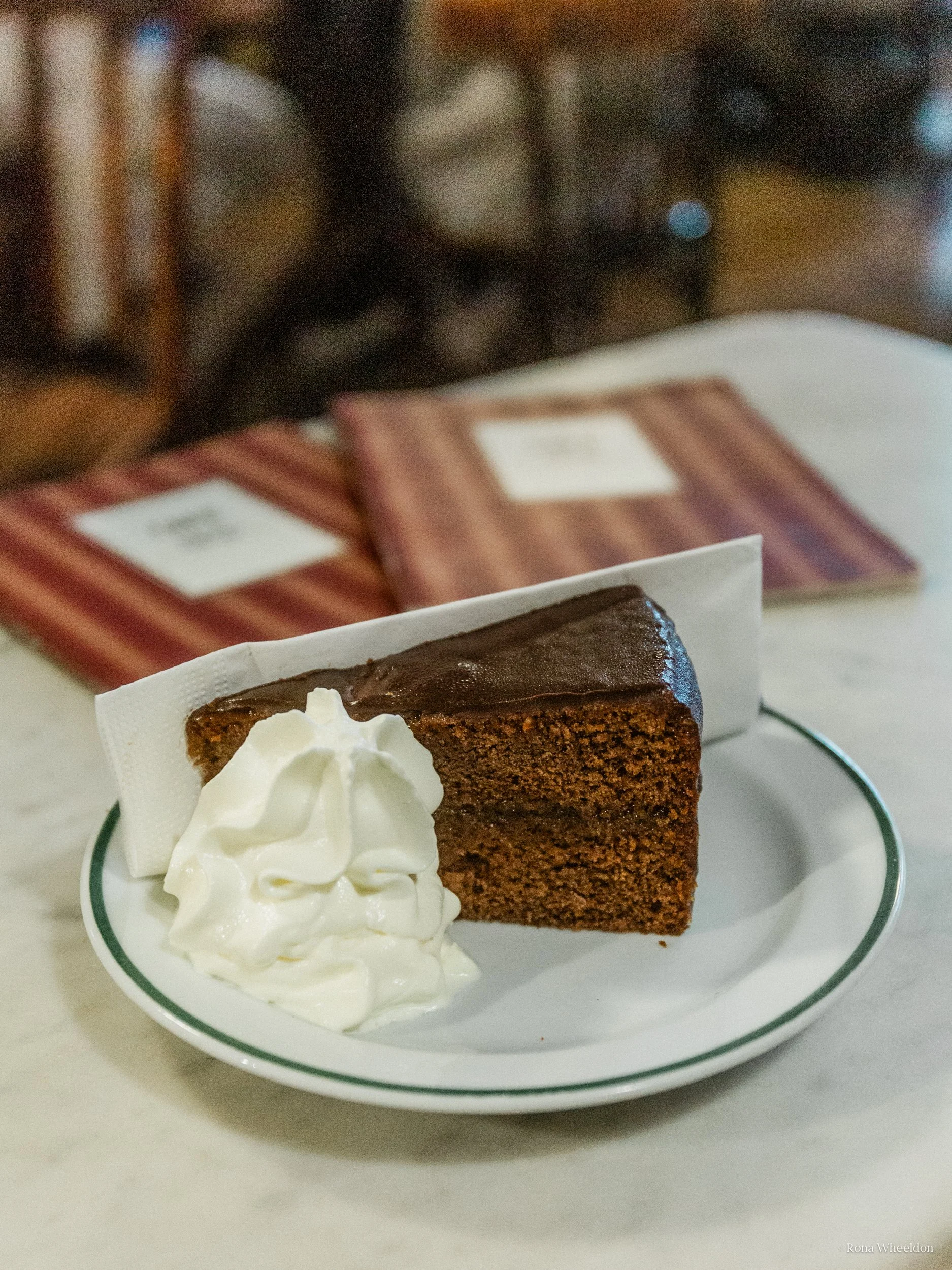Traditional Sachertorte served with whipped cream