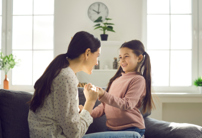 Mother talking to young daughter