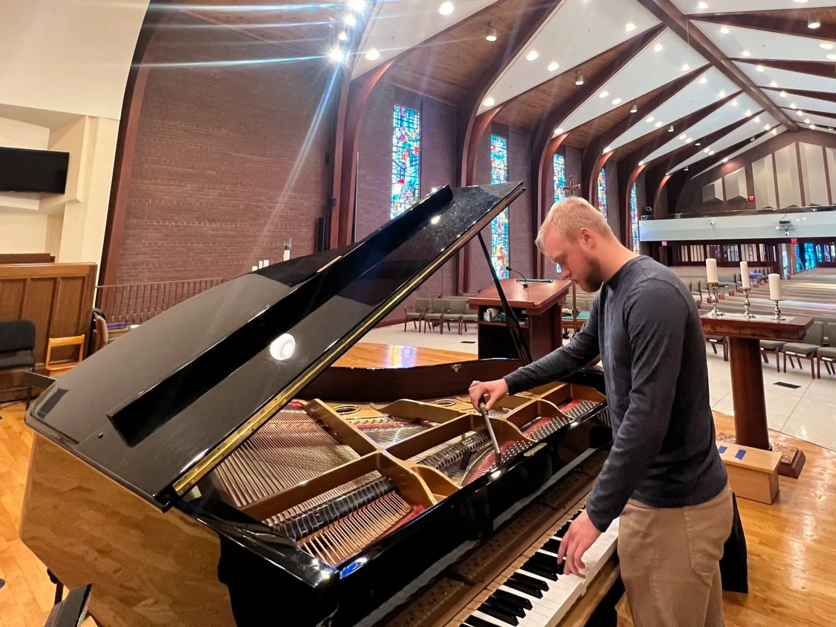 Owner and piano technician Christian Casey tuning the sanctuary piano at Harvey Browne Presbyterian Church.