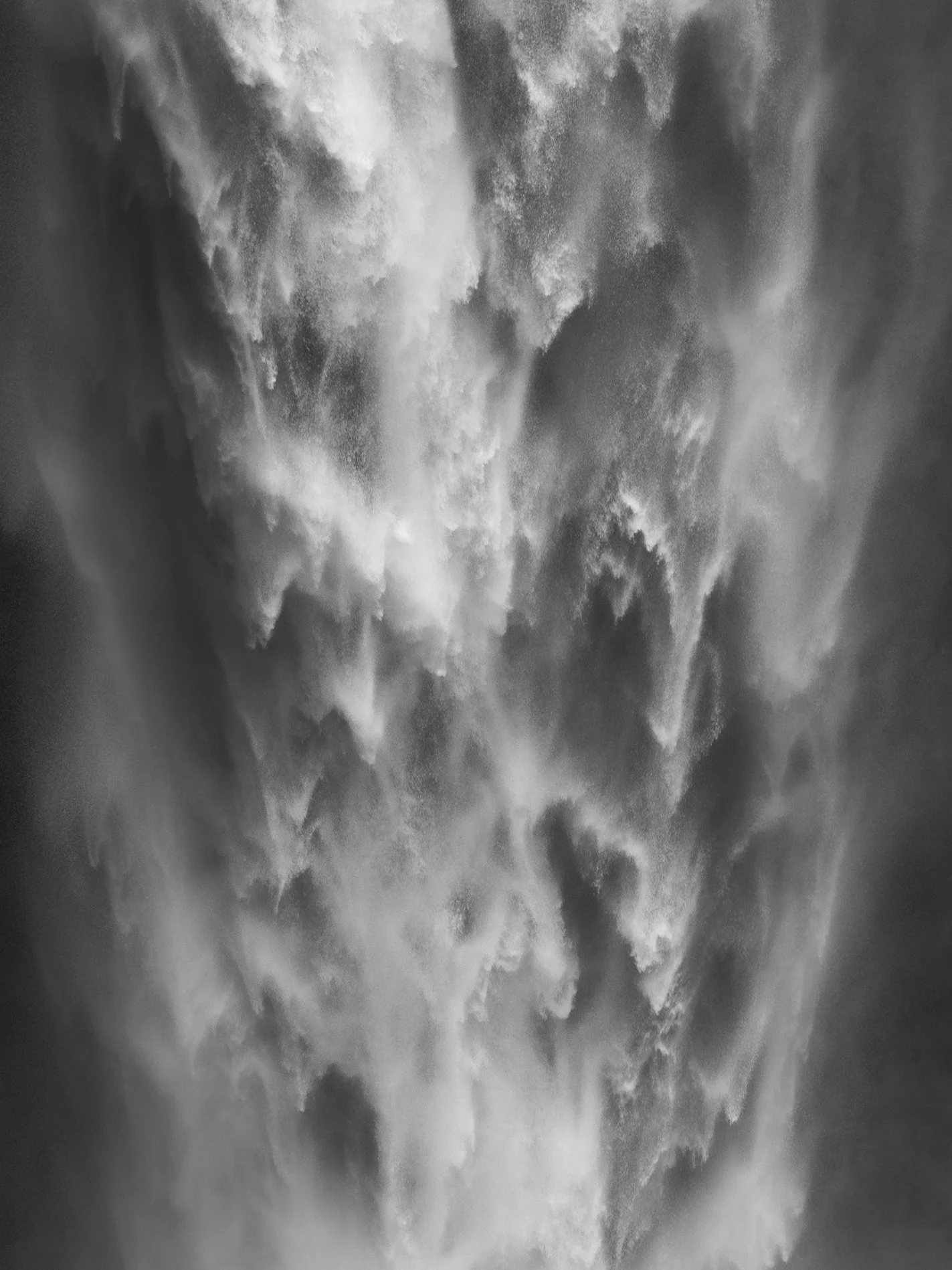 Cloudy sky with dense clouds and light breaking through.