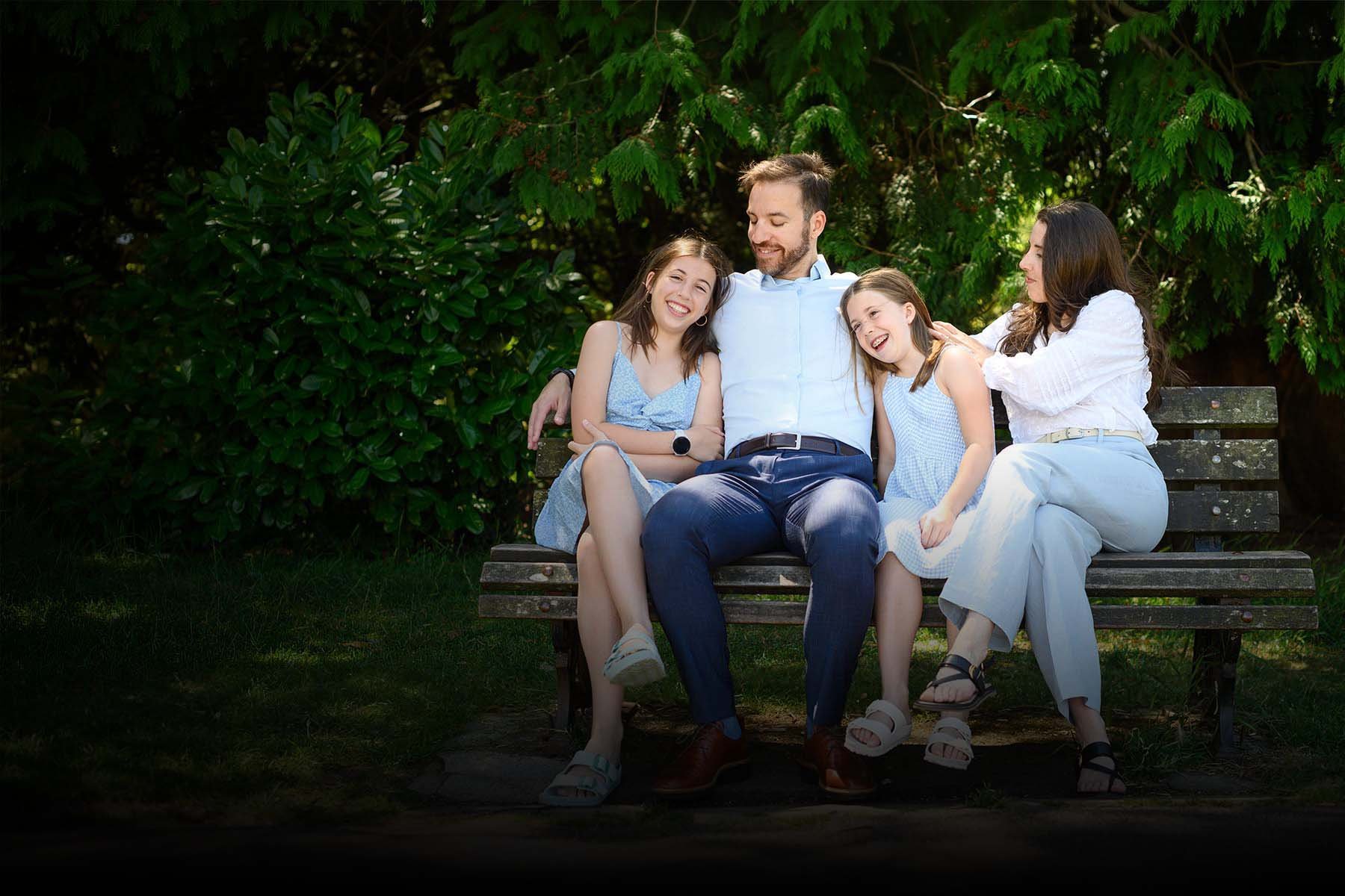 family of four sitting on a bench