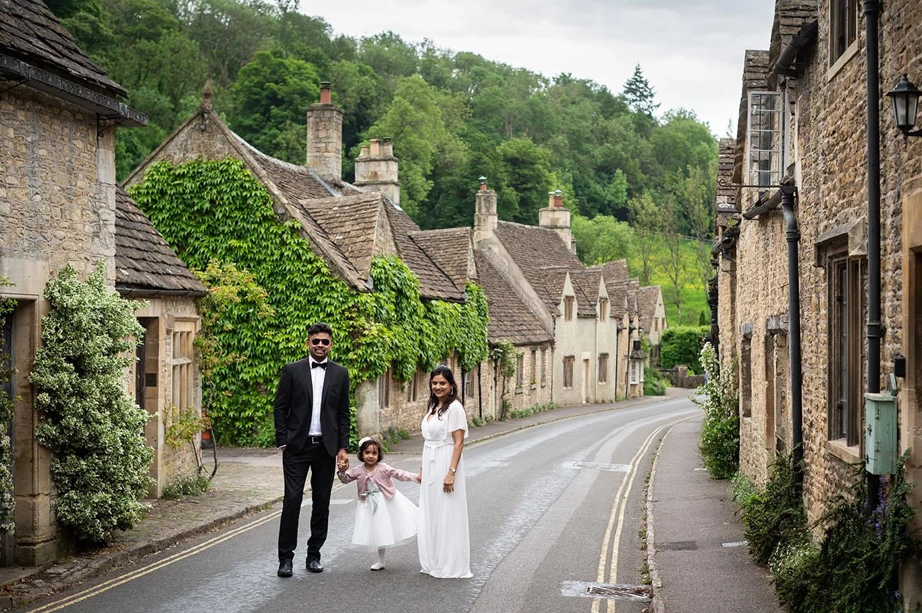 family standing in middle of street in Castle Combe