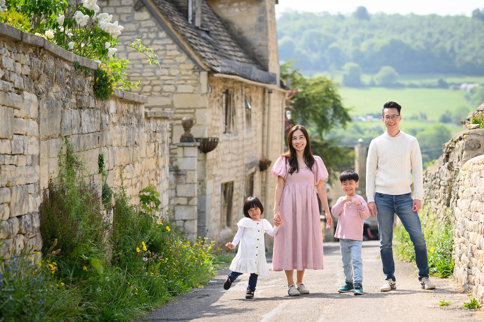 Family of four standing in a street in Painswick