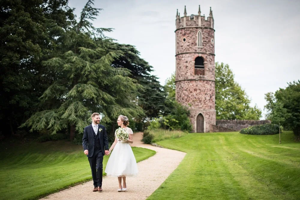Bride and groom taking a stroll through the grounds of Goldney Hall