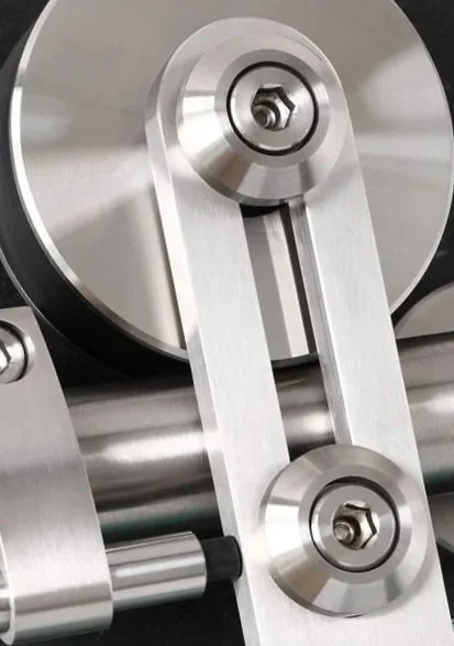 Close-up of a modern, metallic, foldable window hinge mechanism.