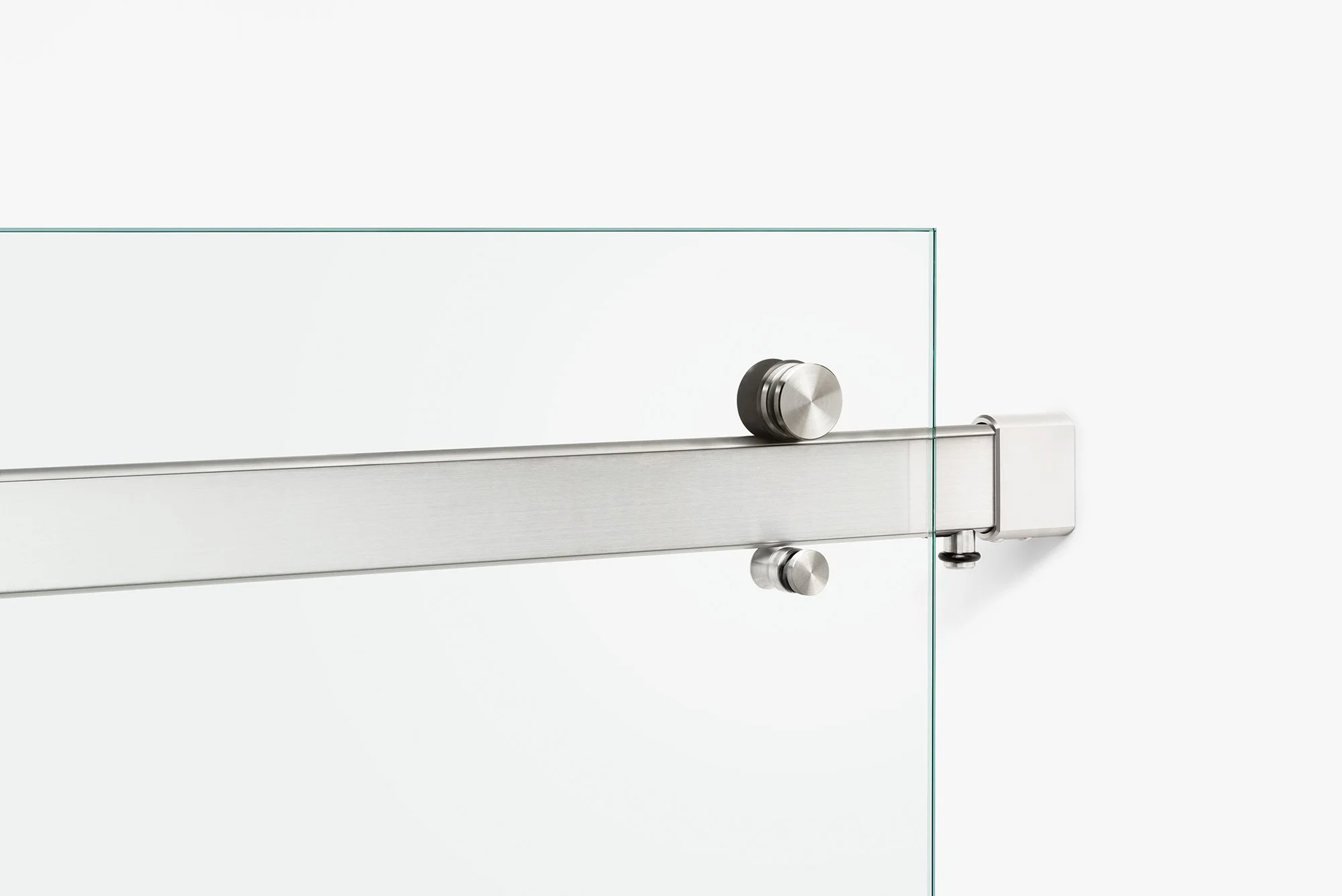 Close-up of a brass metal sliding door lock mechanism with a glass panel.