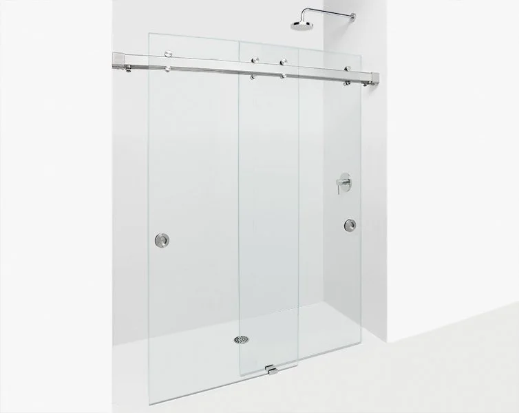 Close-up view of a sliding glass door handle with a modern metallic finish and roller mechanism, mounted on a glass door. Krownlab model