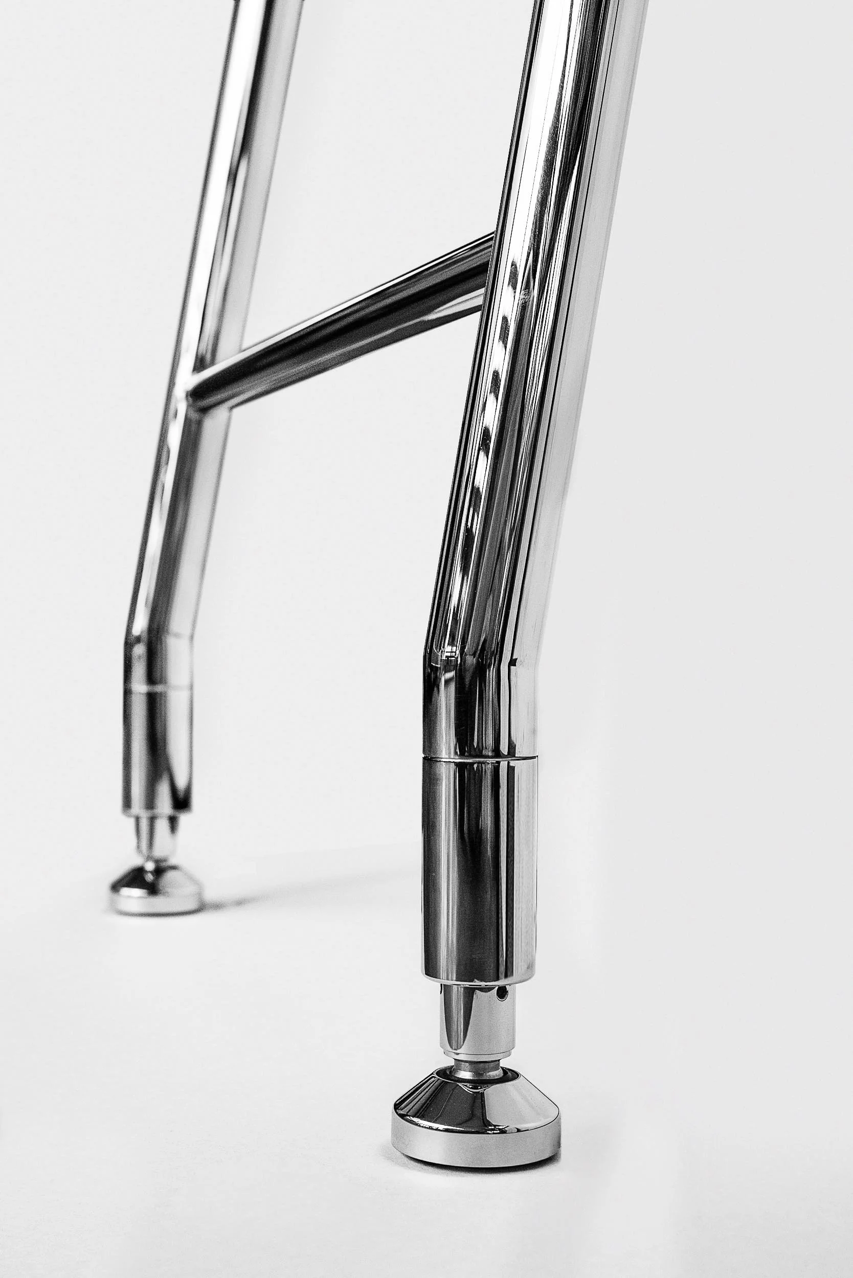 A modern, sleek, silver and black electronic device with a minimalist design, featuring sharp edges and a reflective surface.