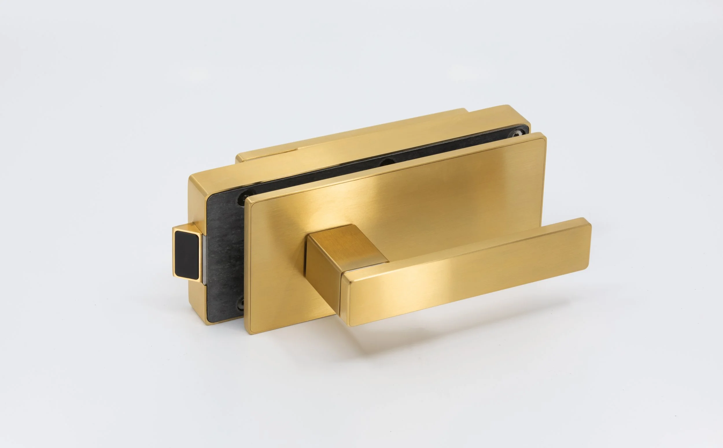 Gold-colored, modern butterfly-style hinge with black rubber cushions on a white background.